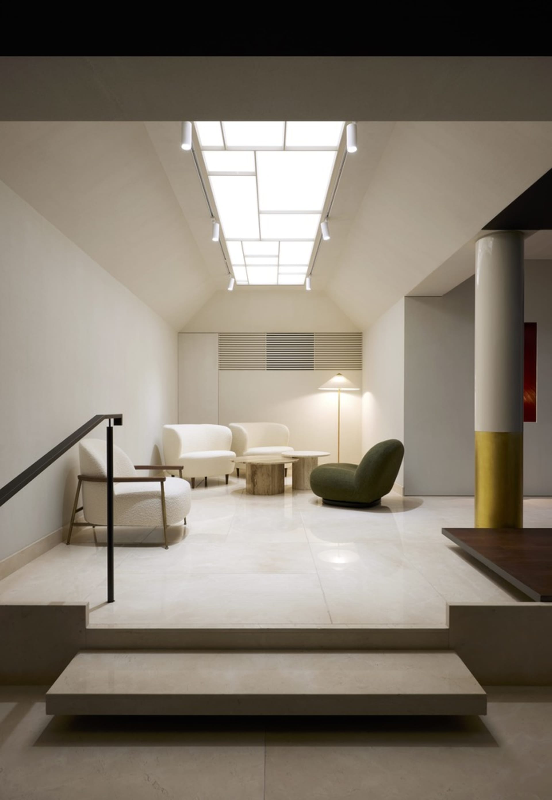 Modern living room with white marble flooring and minimalist furniture arrangement.