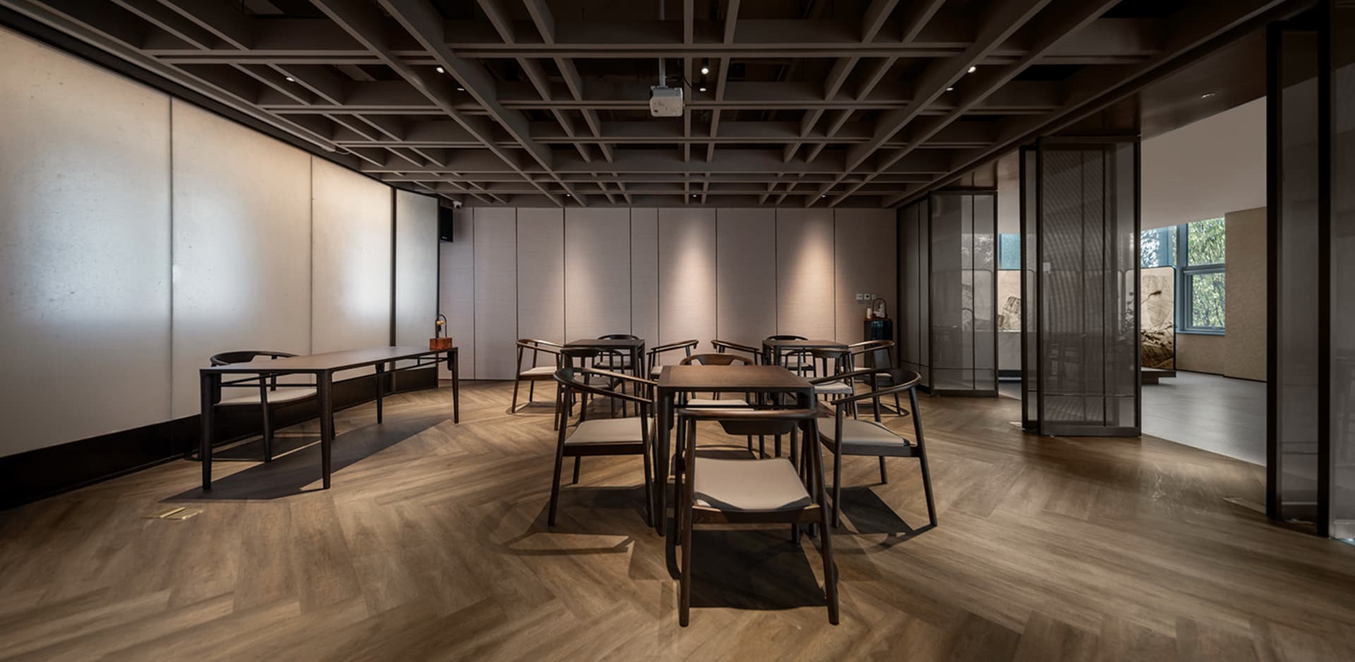 A minimalist cafe with wooden furniture and high ceiling