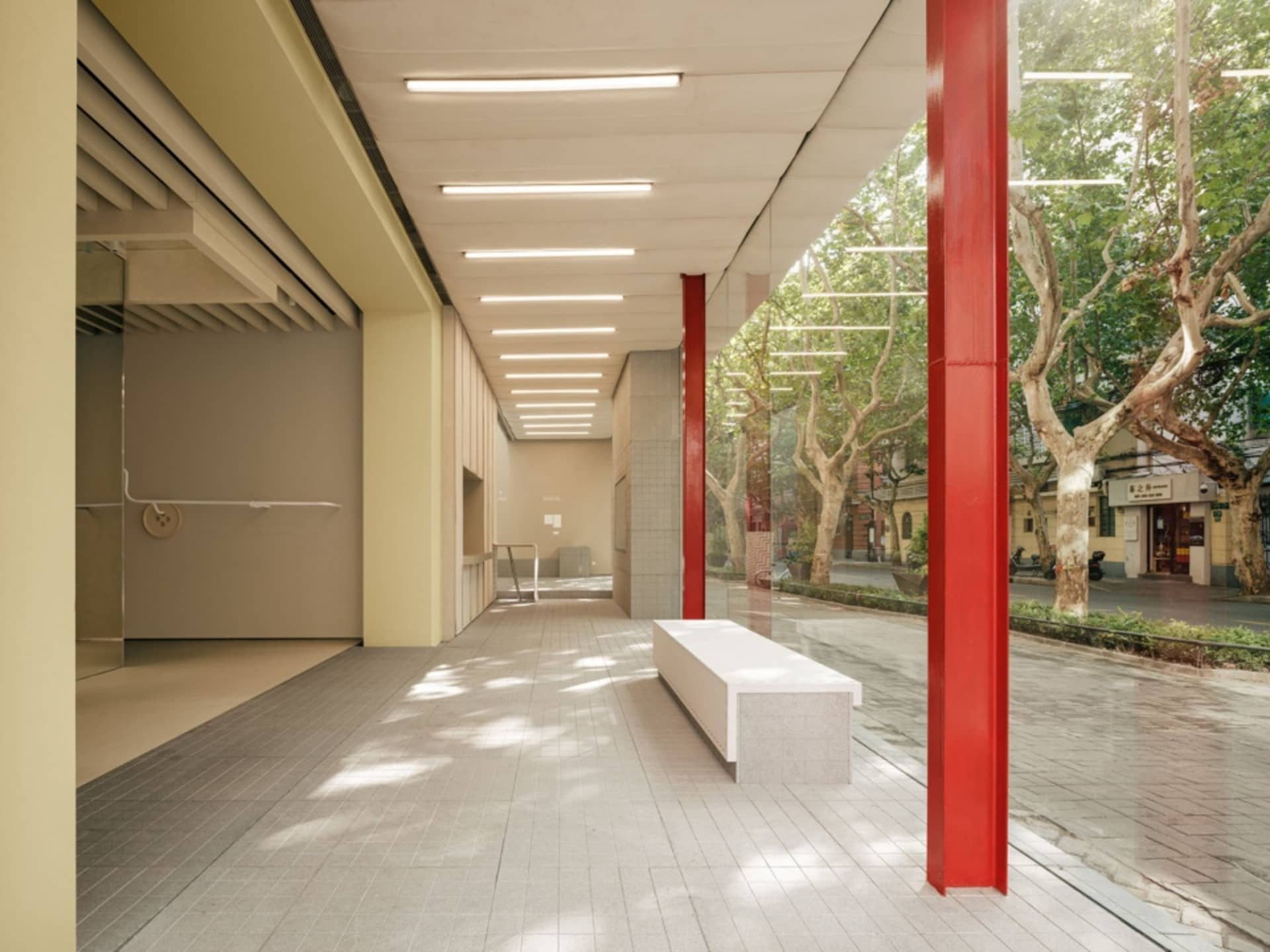 Modern architectural space with concrete walls, glass pillars, and natural light.