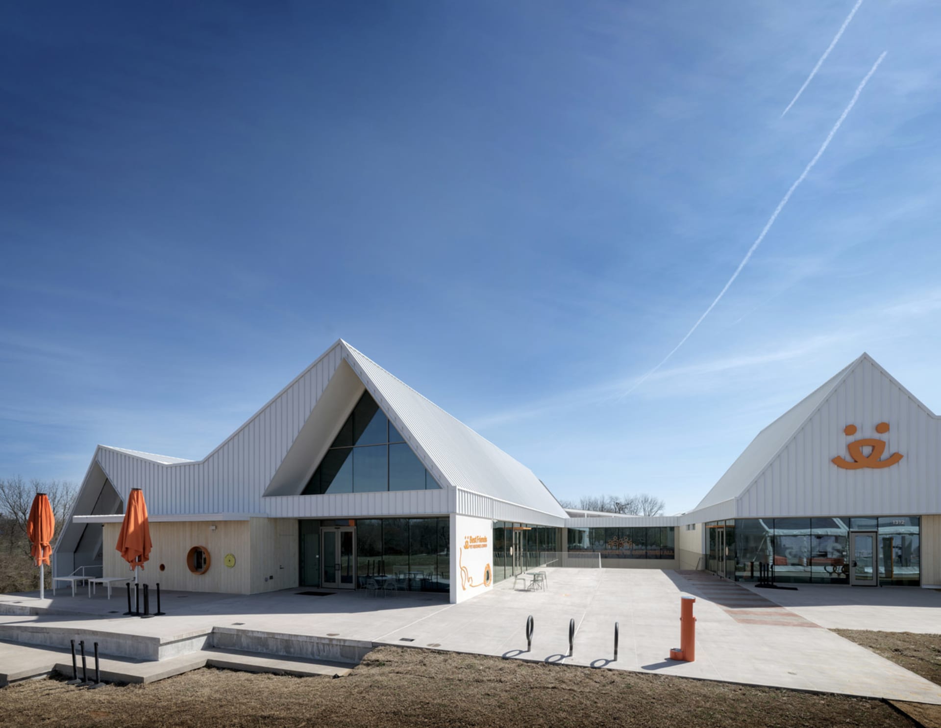 A modern building with a glass exterior on a clear day.