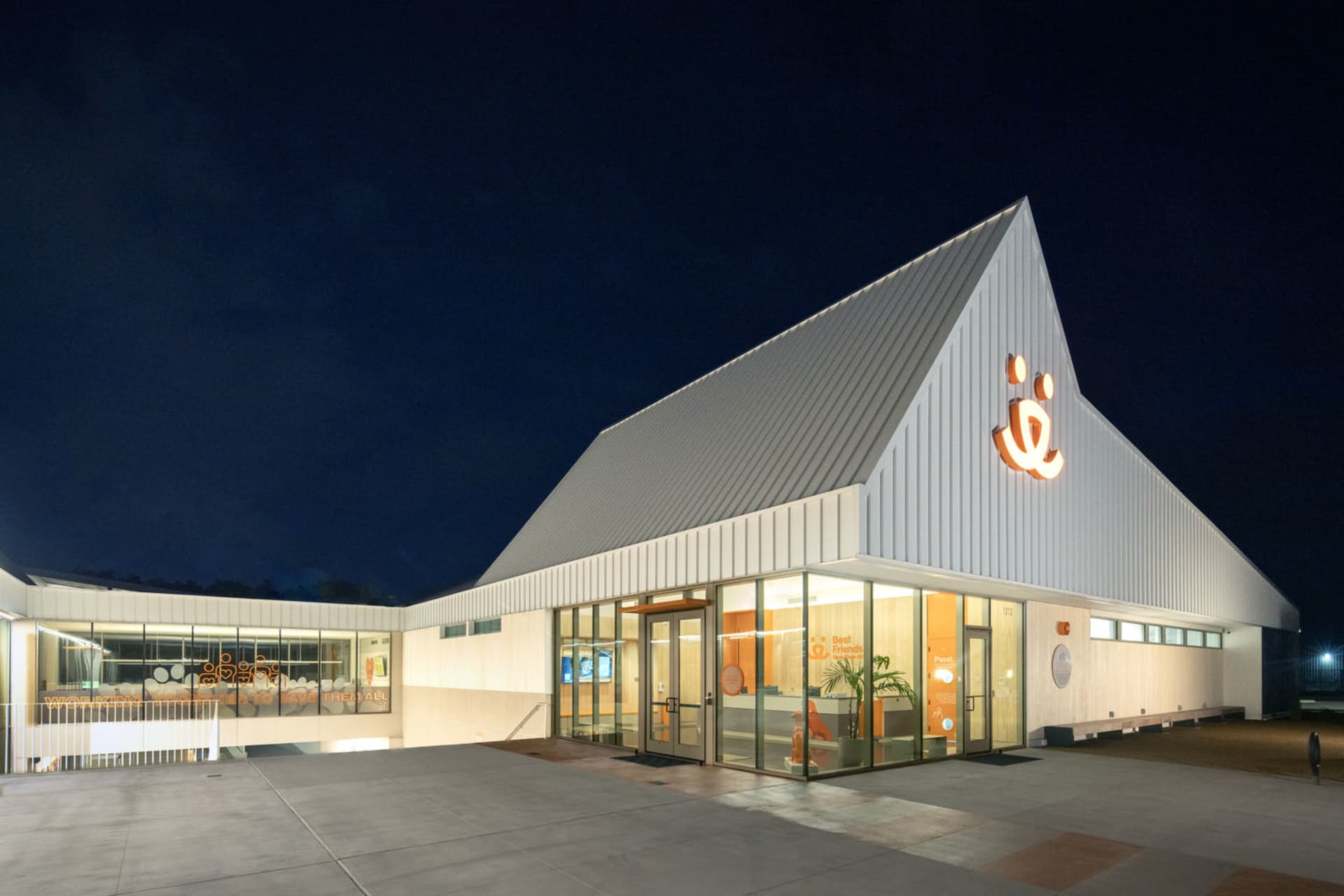 Modern, single-story, office building with a metallic exterior and large glass windows.