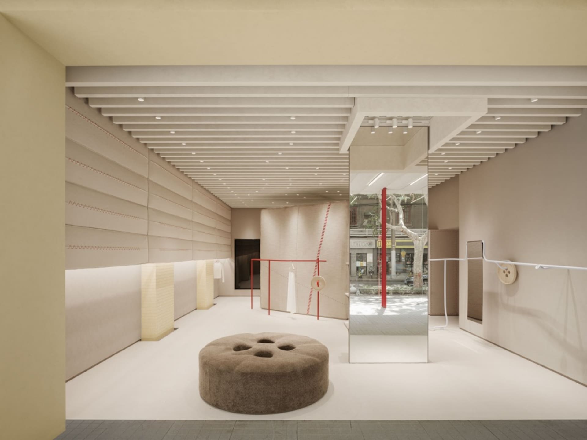 Modern retail store with textured beige walls and red accents