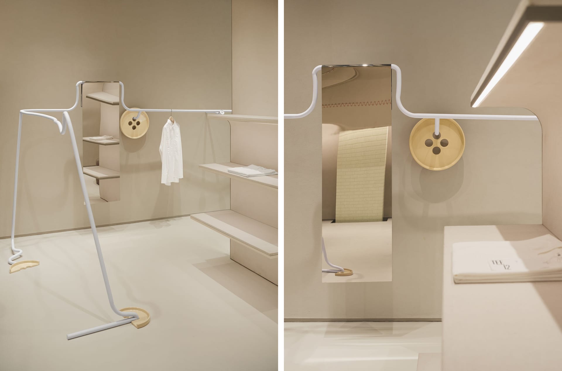 A modern retail store features a white clothing rack with minimalist design and metal accents.
