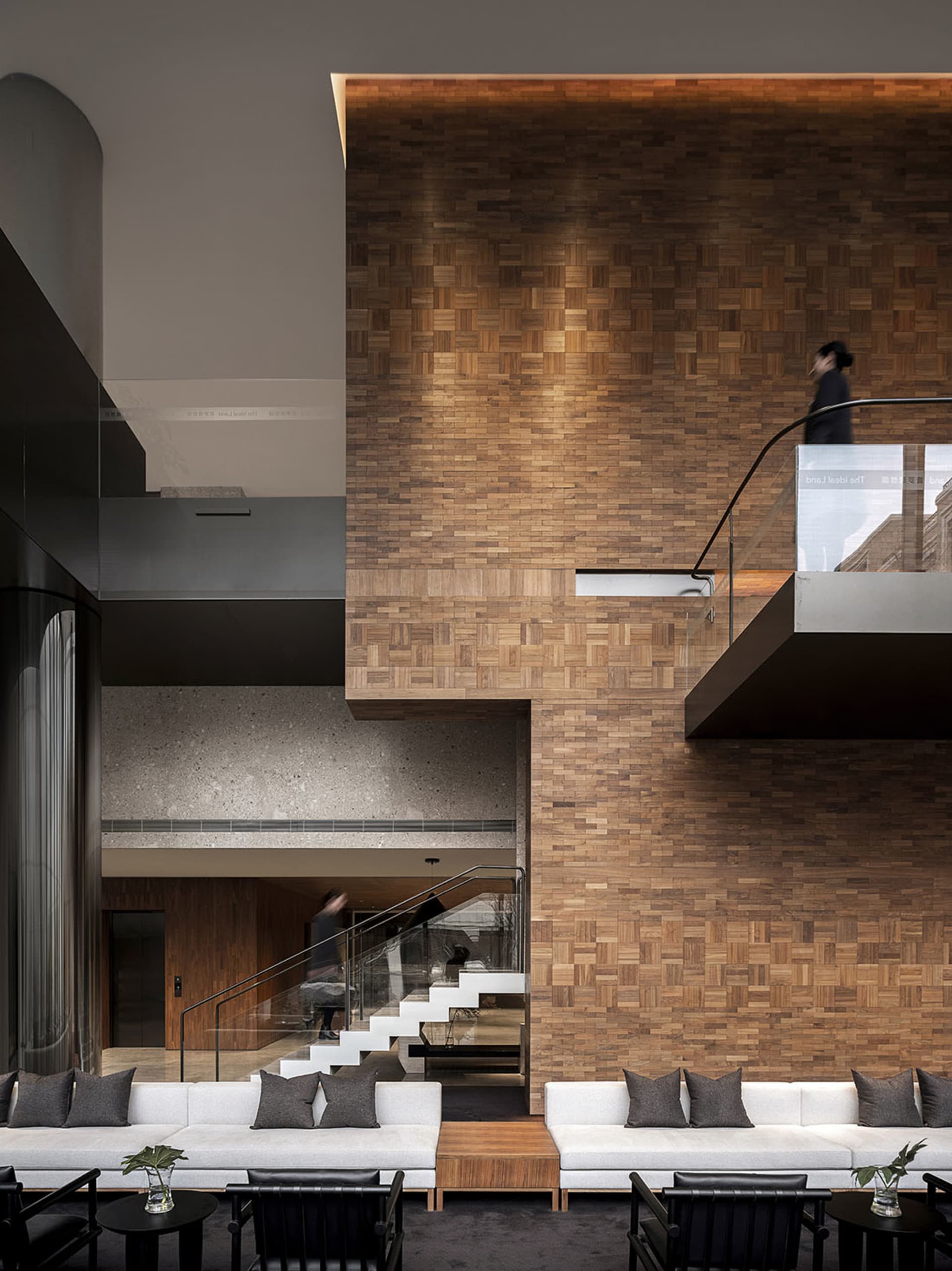 Modern architectural space featuring a wooden panel wall and contemporary furniture.