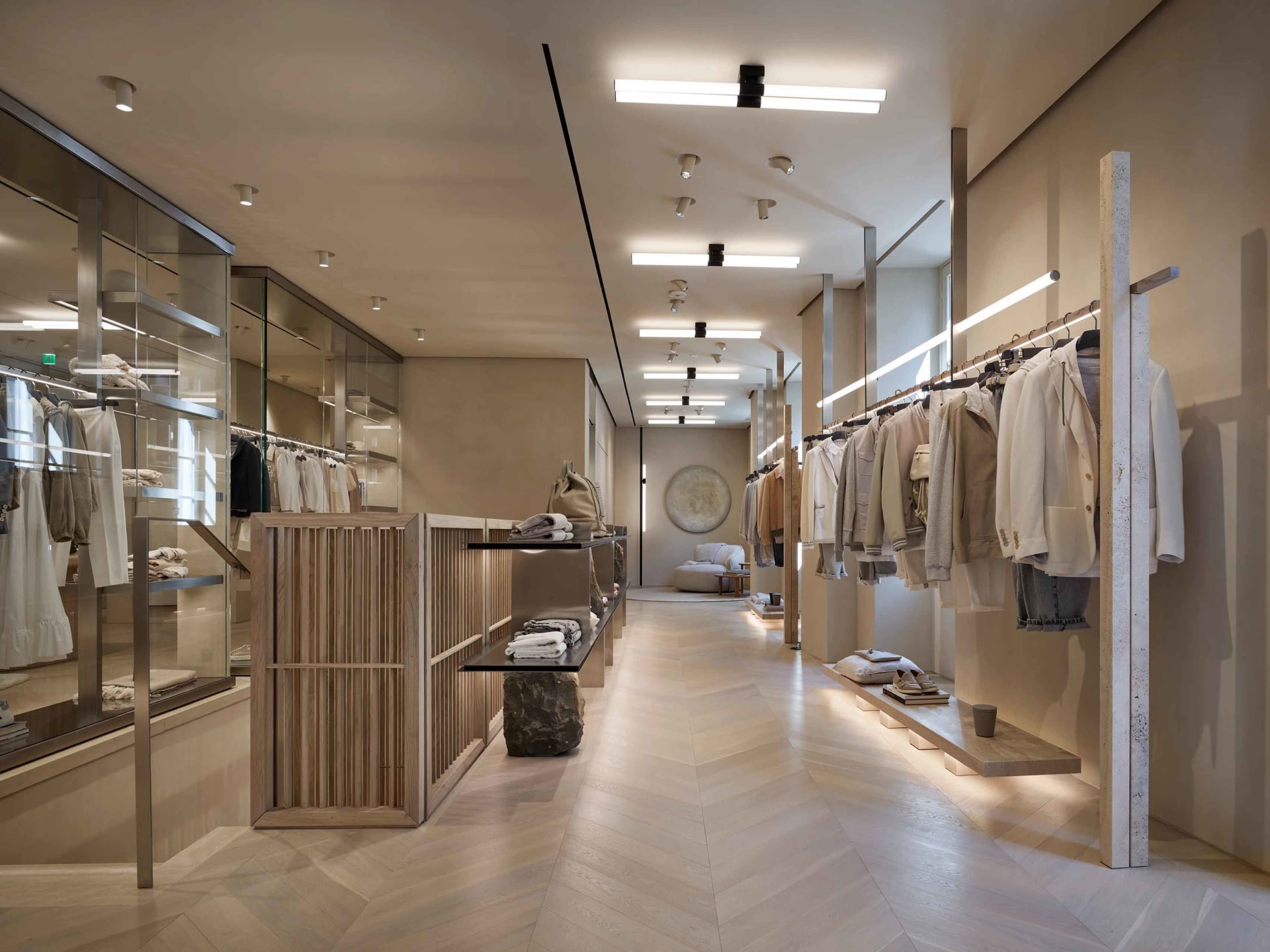 Modern retail clothing store showcasing contemporary design features made of concrete, wood, and glass materials.
