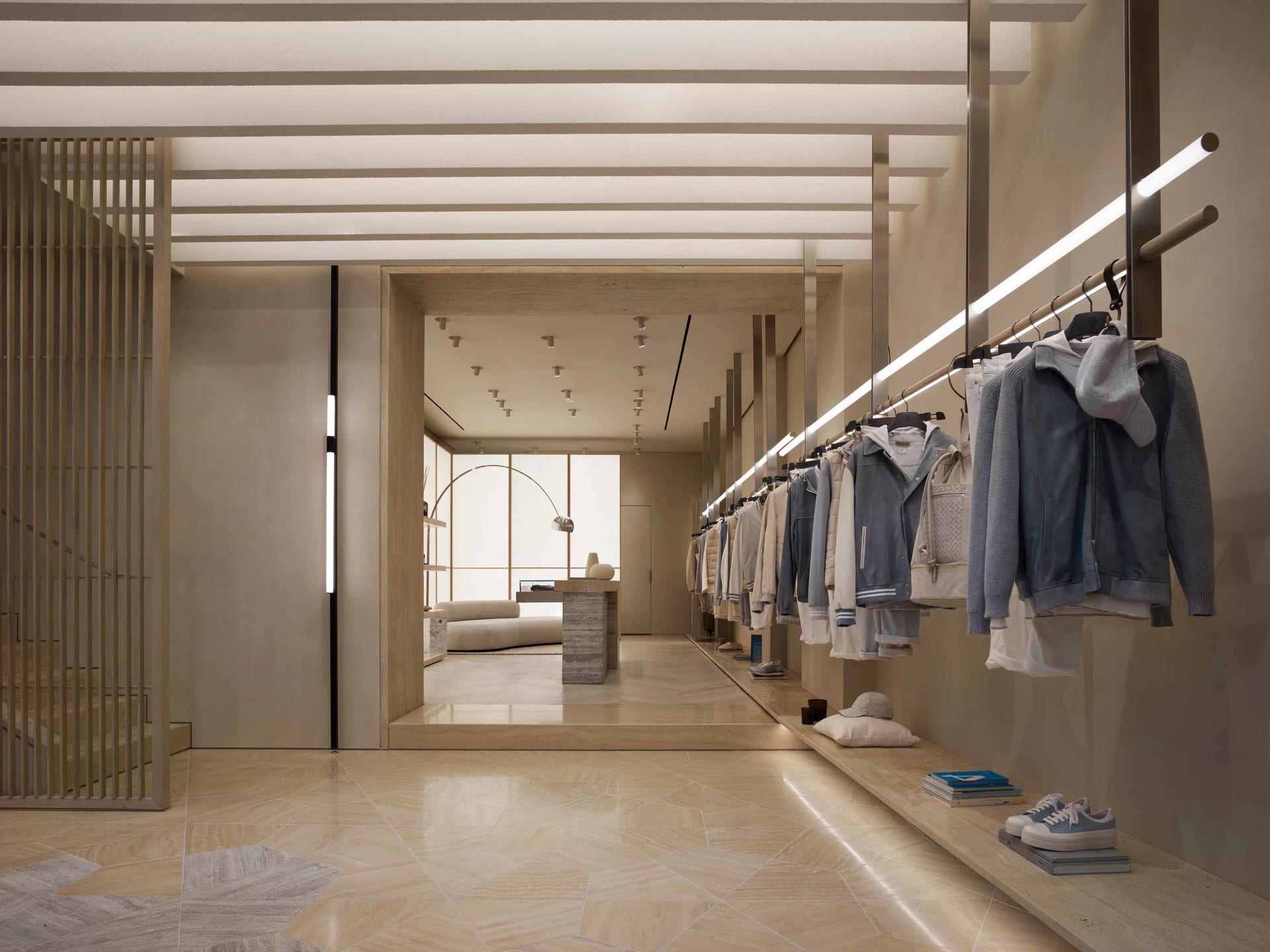A modern retail interior featuring neatly hung clothing items in a contemporary setting.