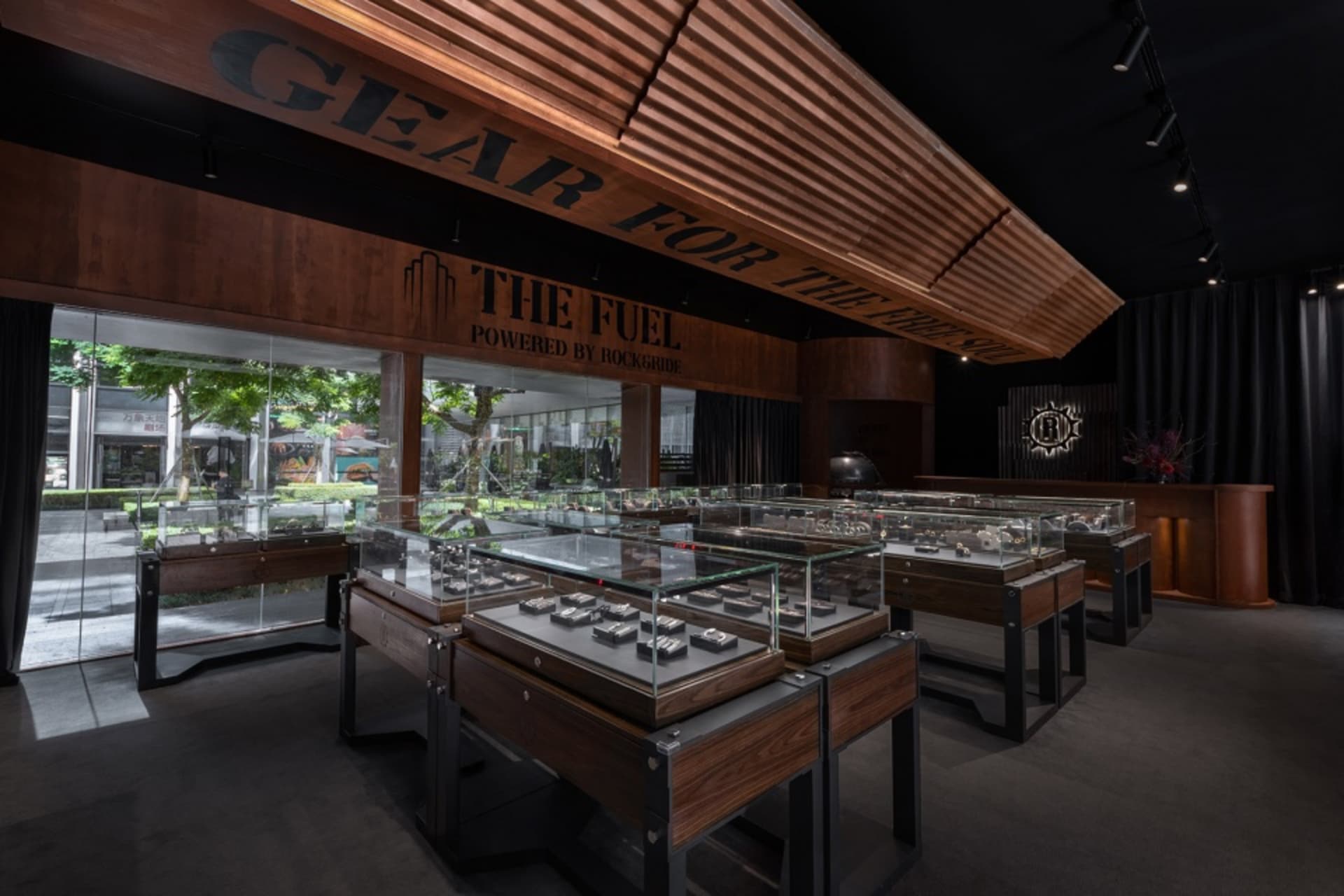Modern retail shop interior with jewelry displays, wooden accents, and glass cases.