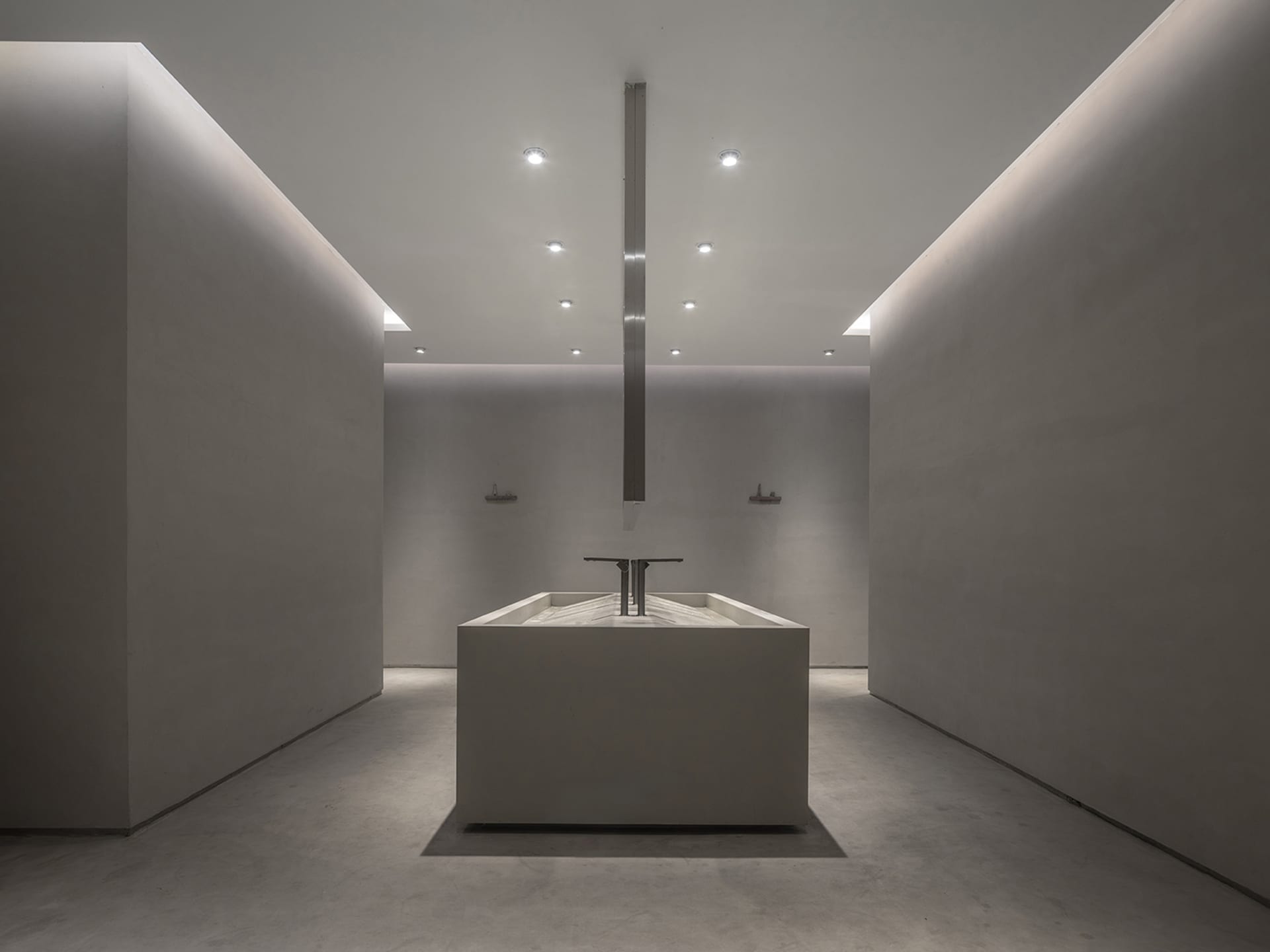 Modern minimalist bathroom featuring a concrete sink and floor.