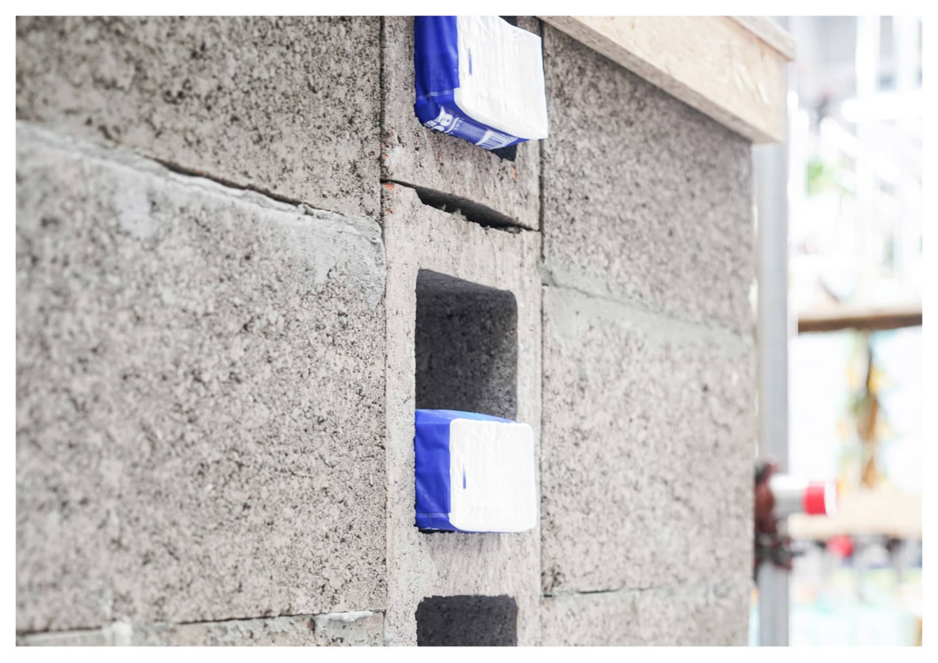 Concrete blocks with blue and white objects attached to them