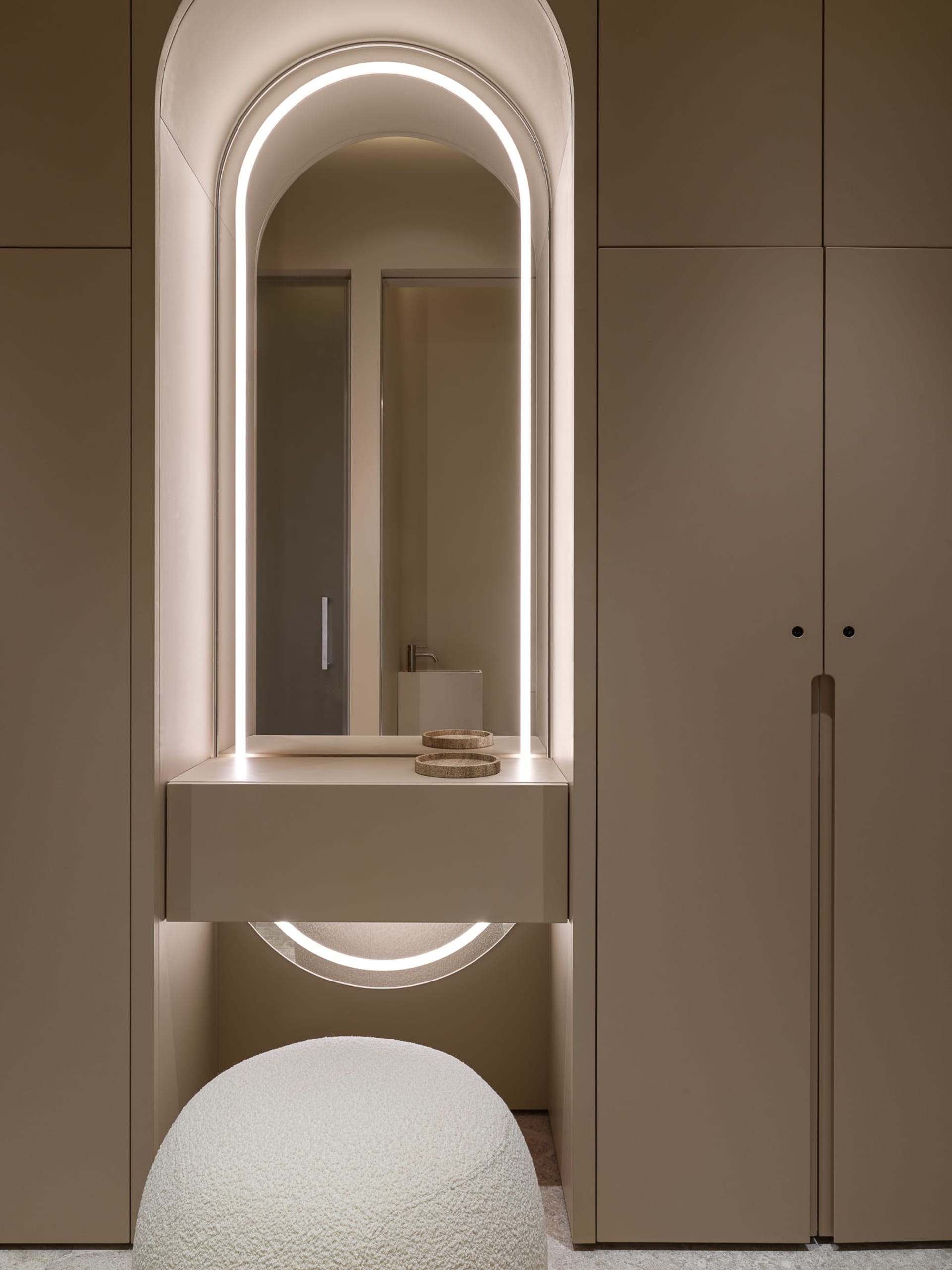 Modern bathroom interior with neutral-toned materials and a minimalist design.