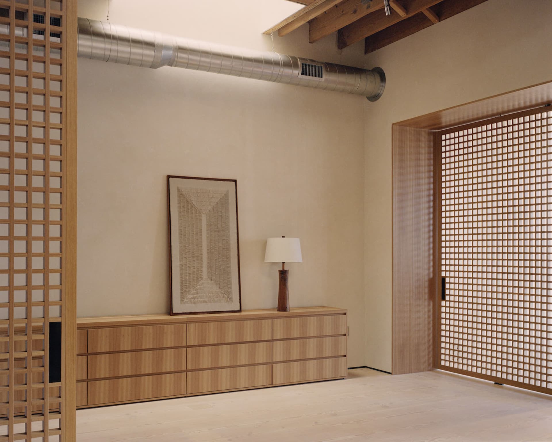 A modern-industrial living space featuring wooden furniture and decor.