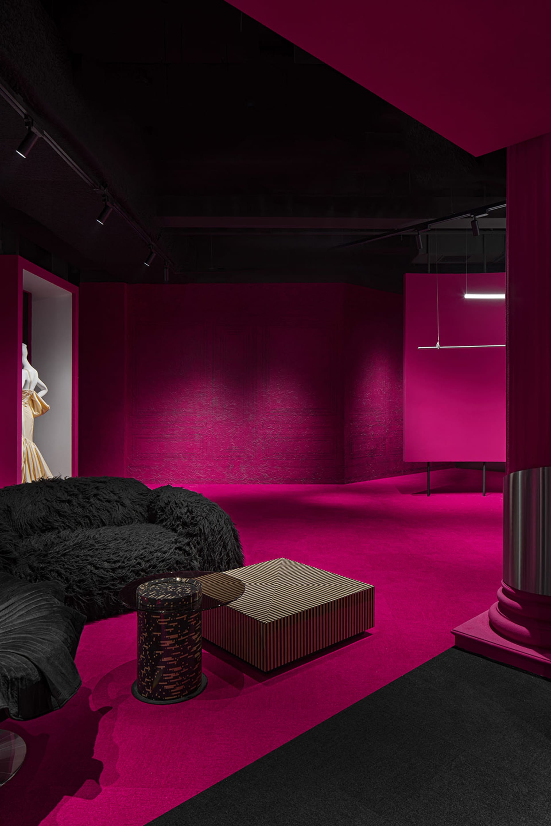 A modern retail storefront with pink paneling on the wall.