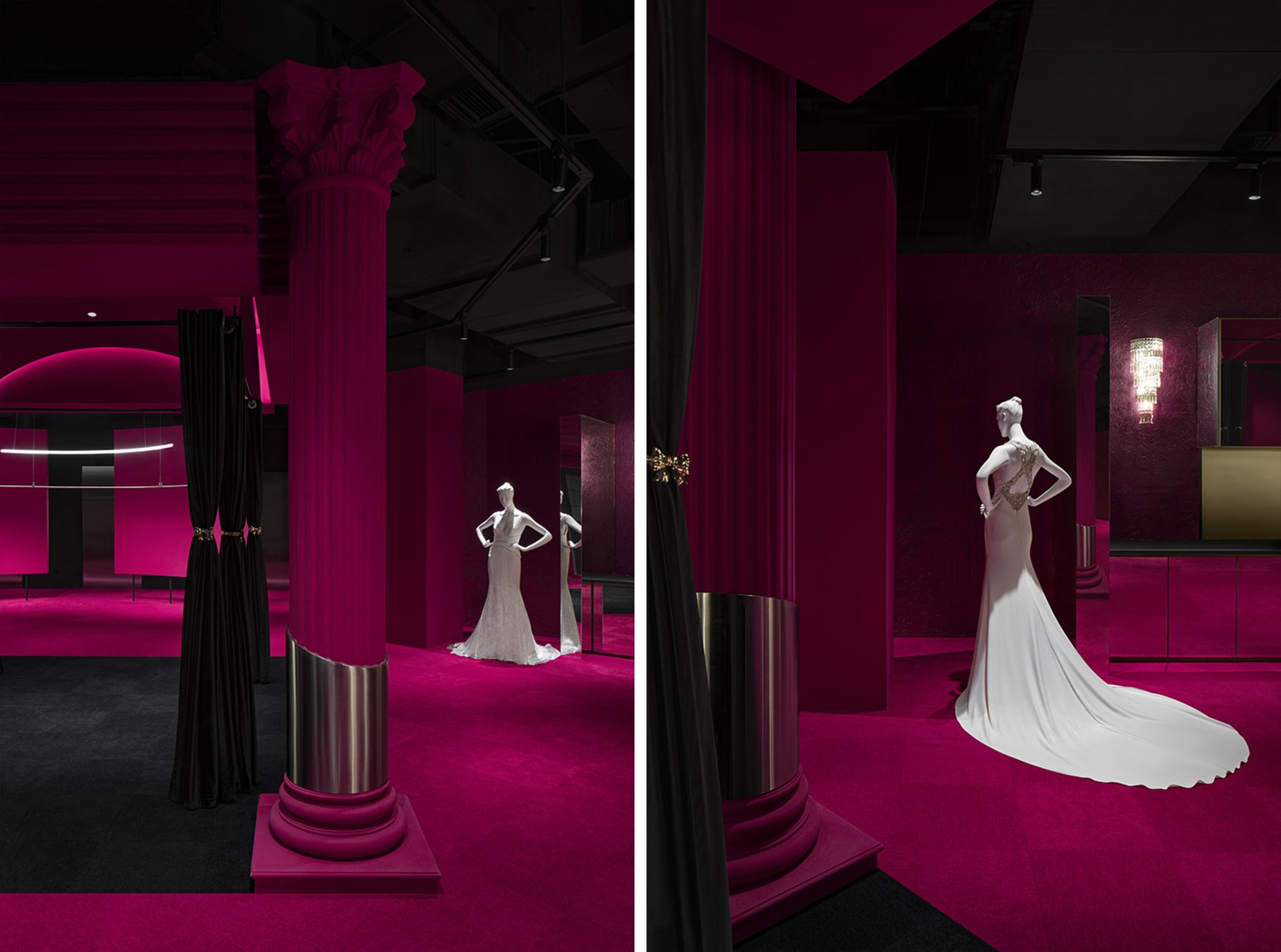 A pink exhibition space with a mannequin wearing a long white dress on a platform, surrounded by black curtains and a black c