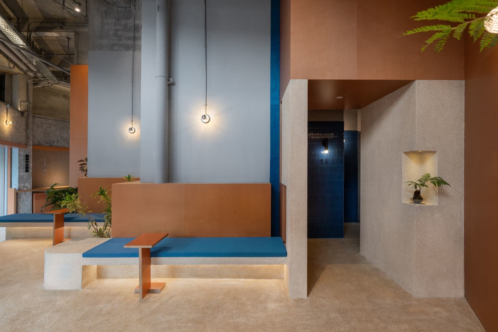 Industrial-themed coffee shop featuring concrete furnishings and minimalist design