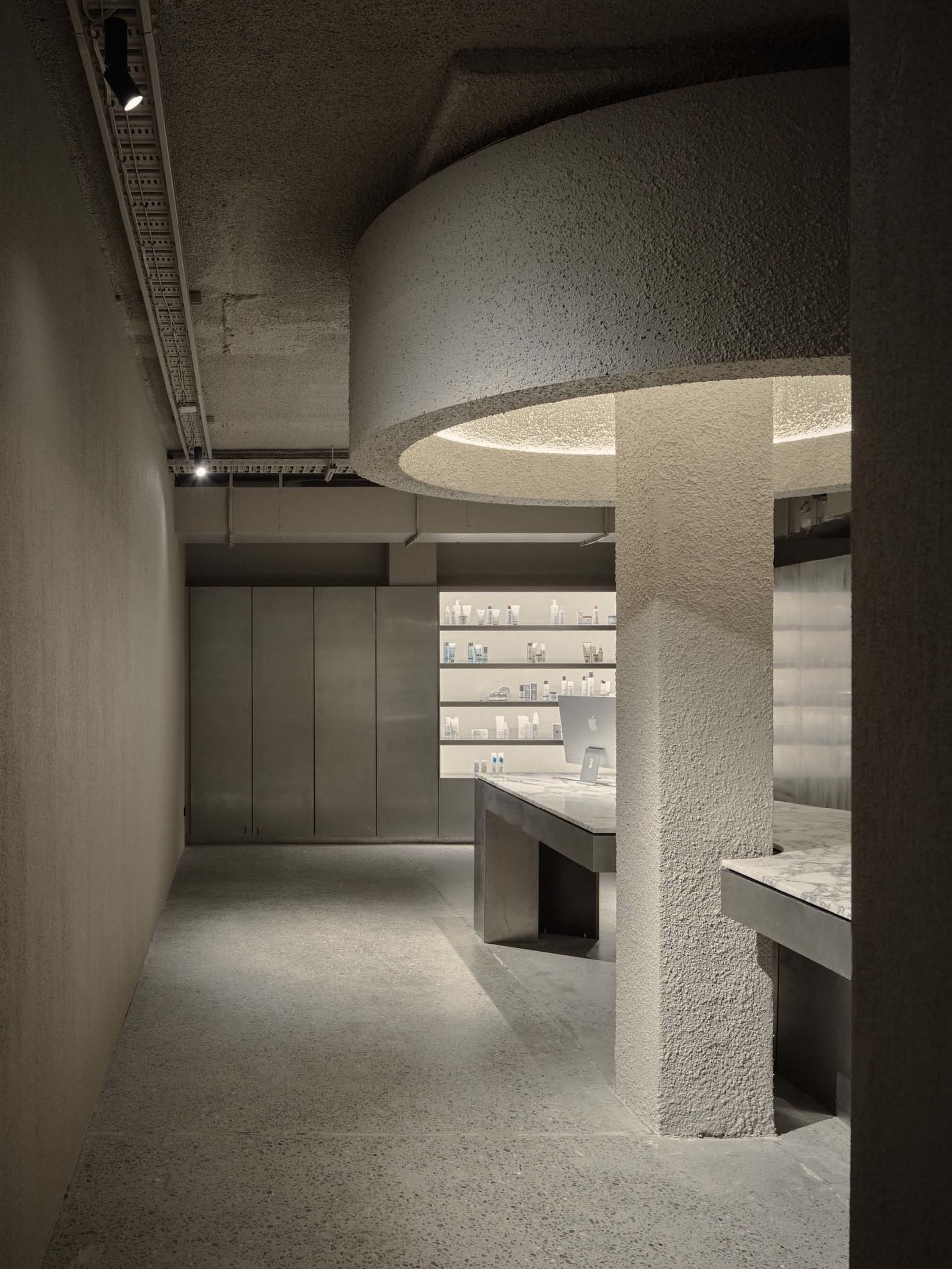 A modern retail storefront with concrete elements and minimalist design.