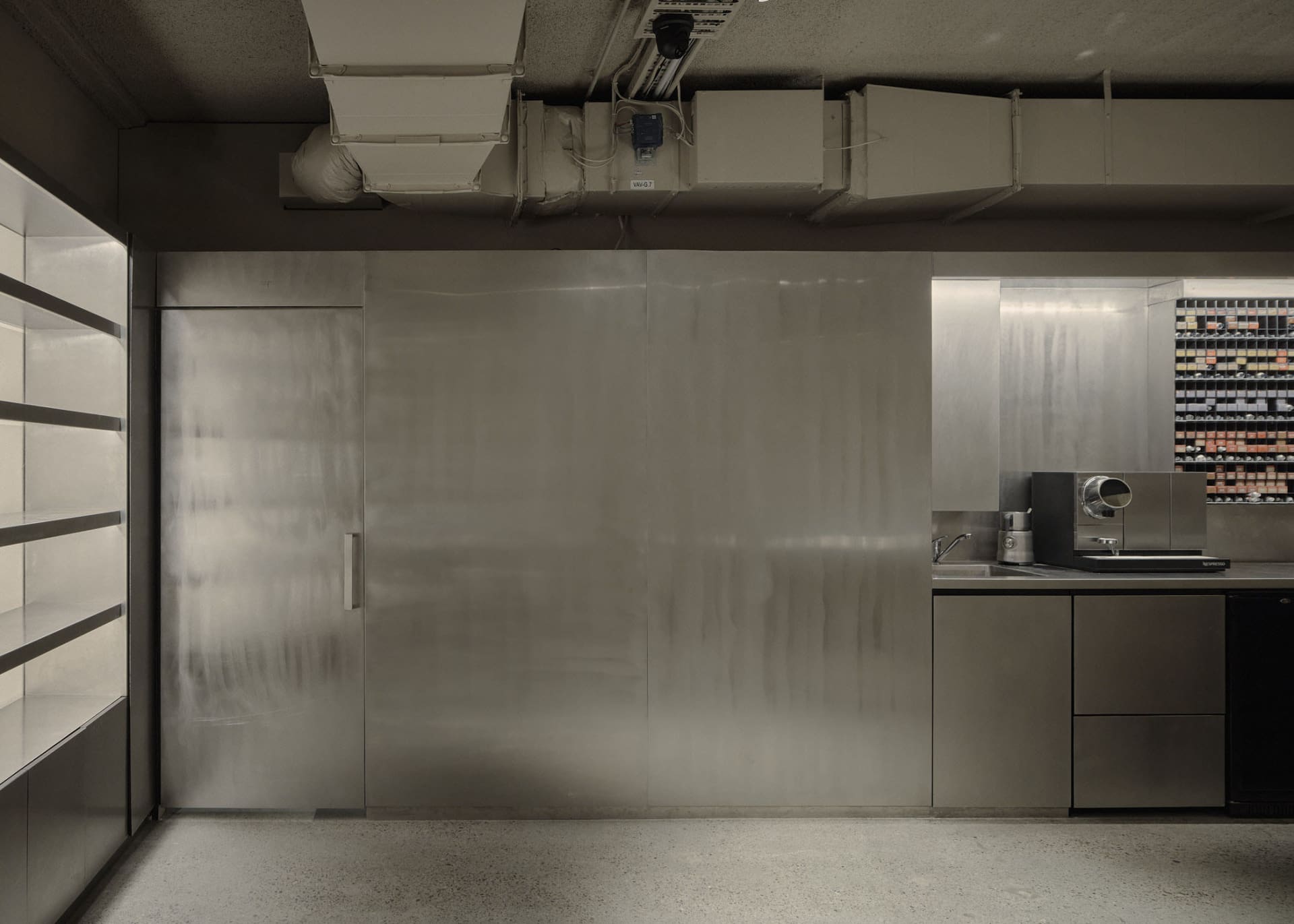 Industrial kitchen with stainless steel appliances and walls