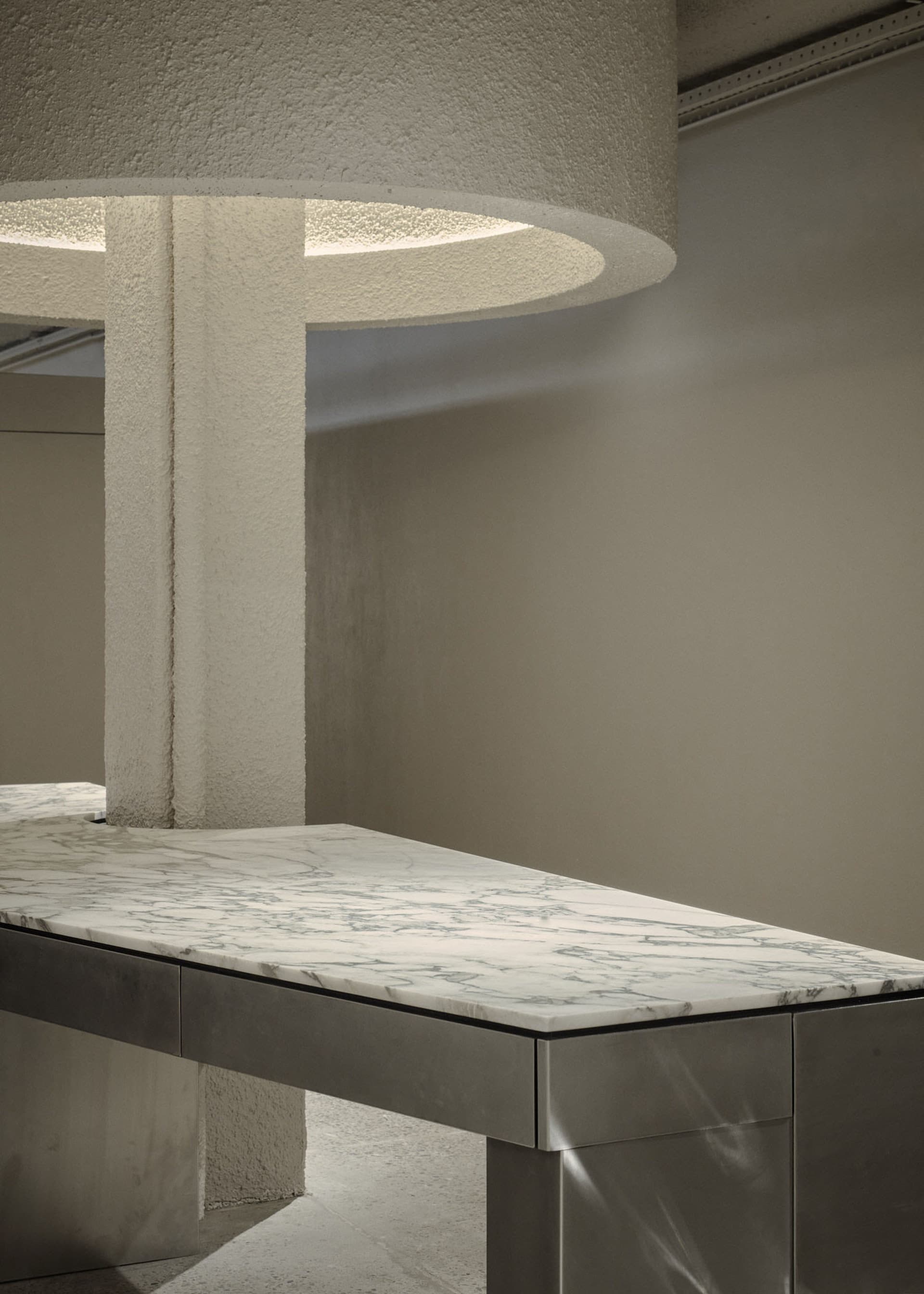 A modern interior featuring a marble and concrete countertop.