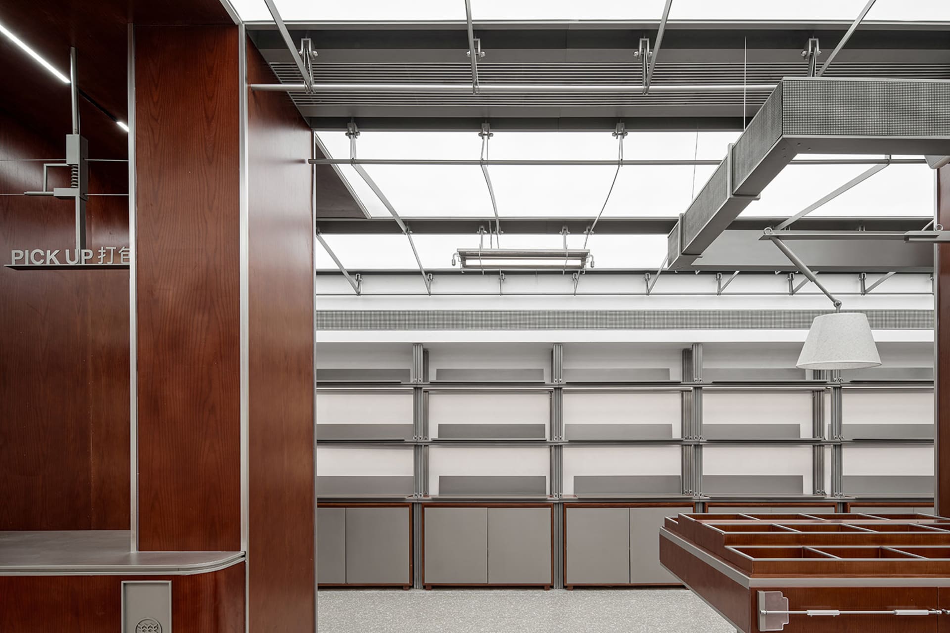 A modern library interior with metal shelves, wooden accents, and industrial lighting.