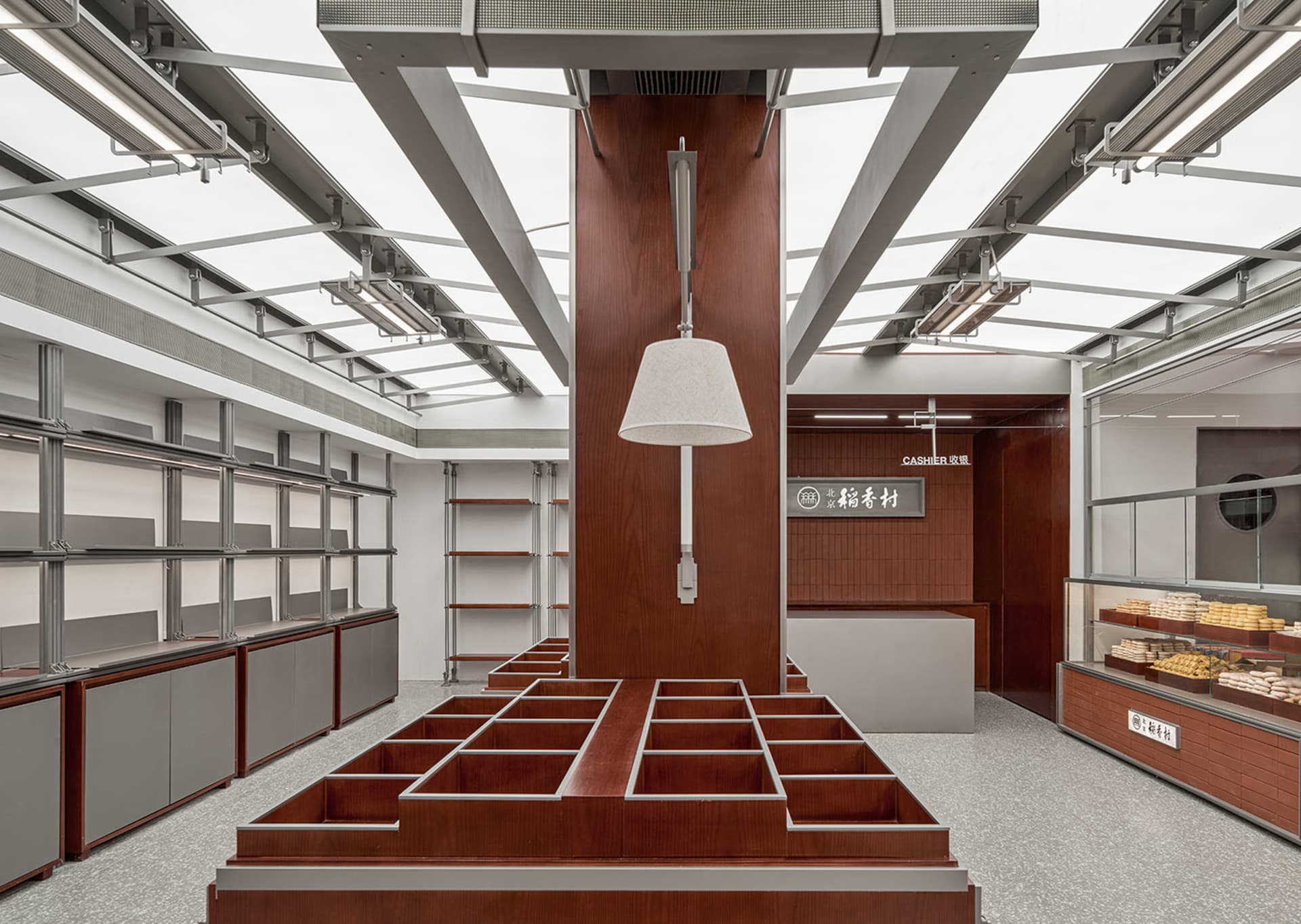 A retail storefront with wooden shelves and a central wooden structure with a hanging light fixture.
