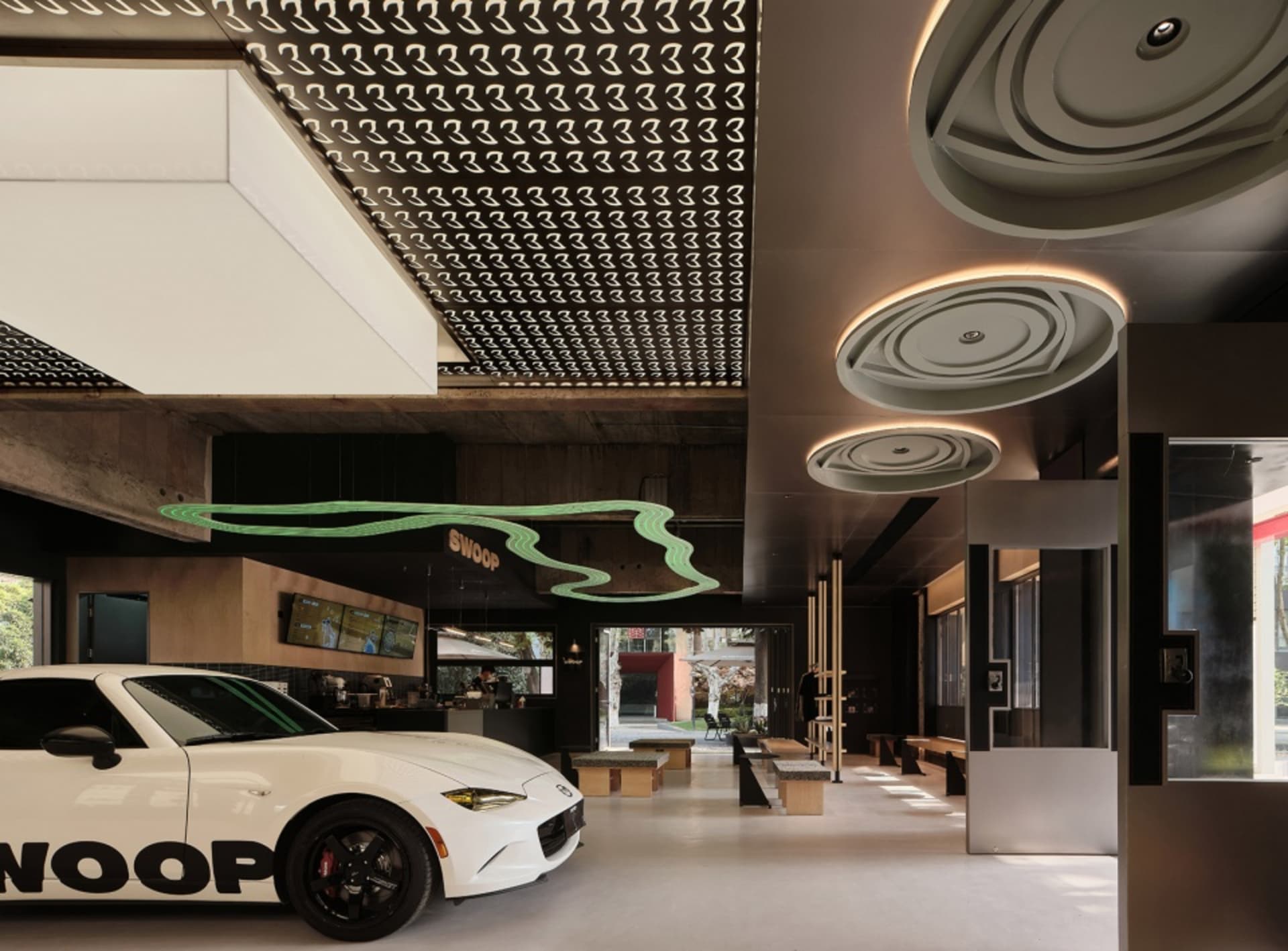 Modern lobby interior with concrete ceiling and minimalist design.