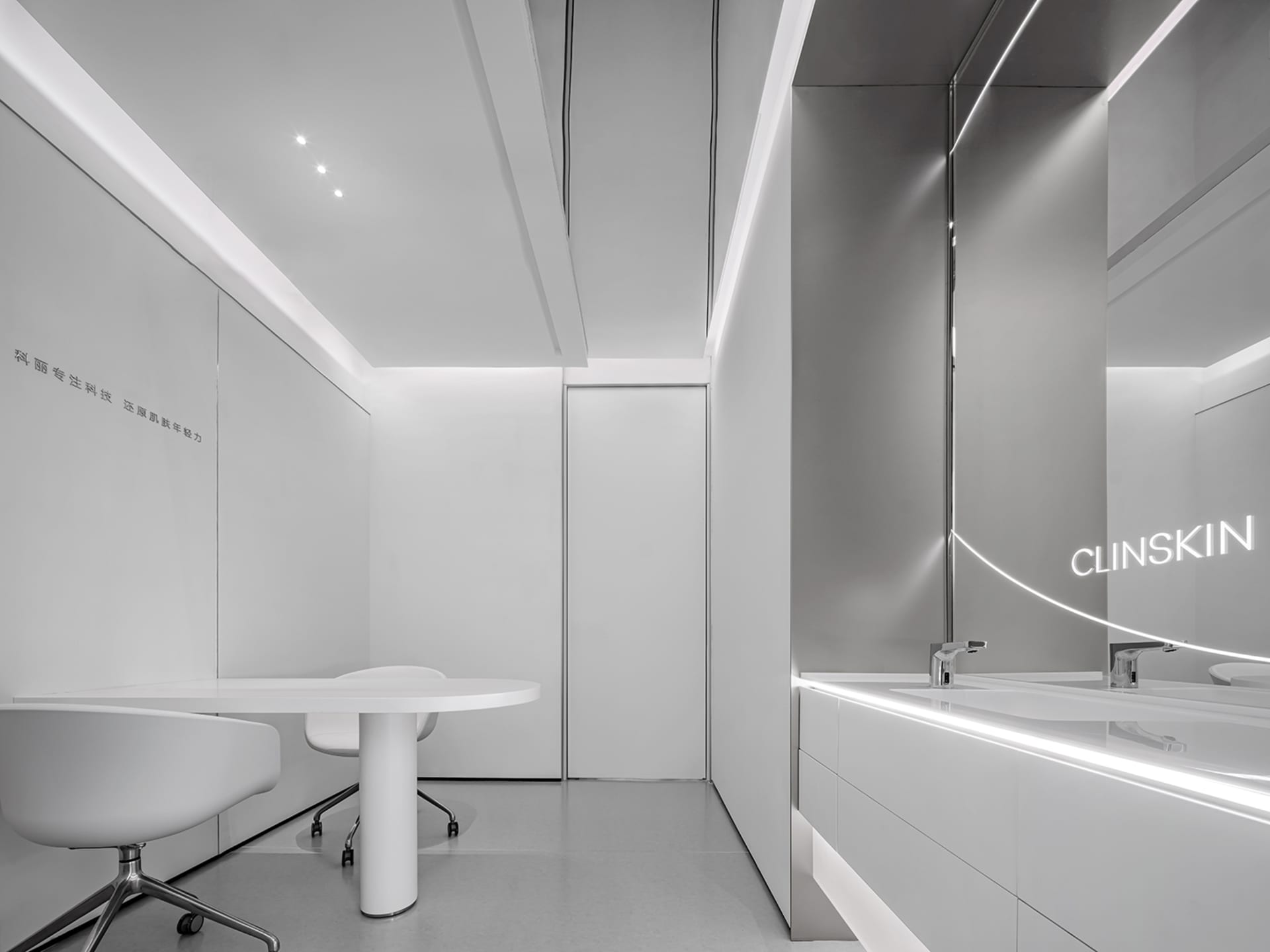 Modern office space with minimalistic design, featuring sleek white furniture and a white podium with a chair.