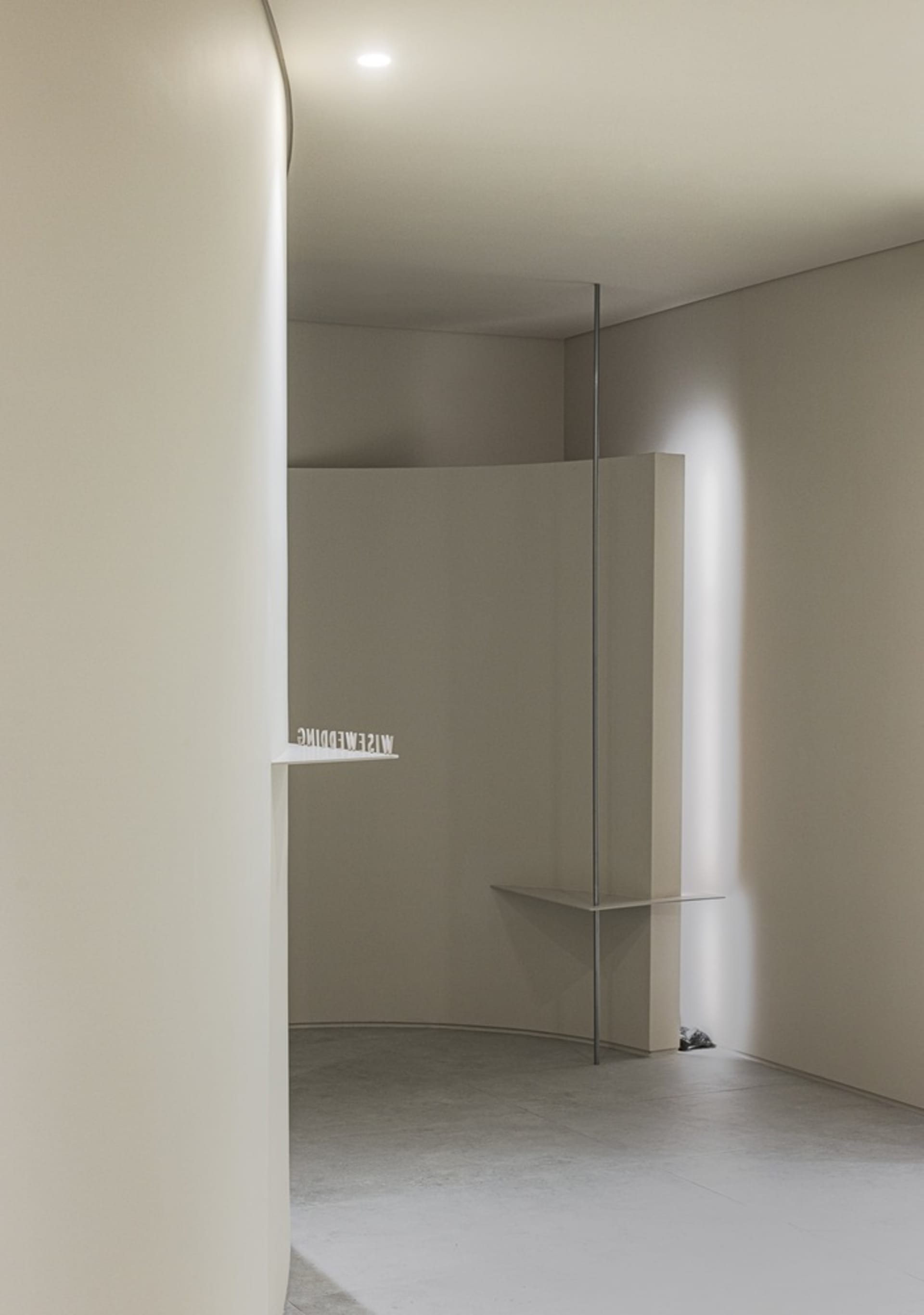 Minimalist interior design featuring concrete materials and clean lines.