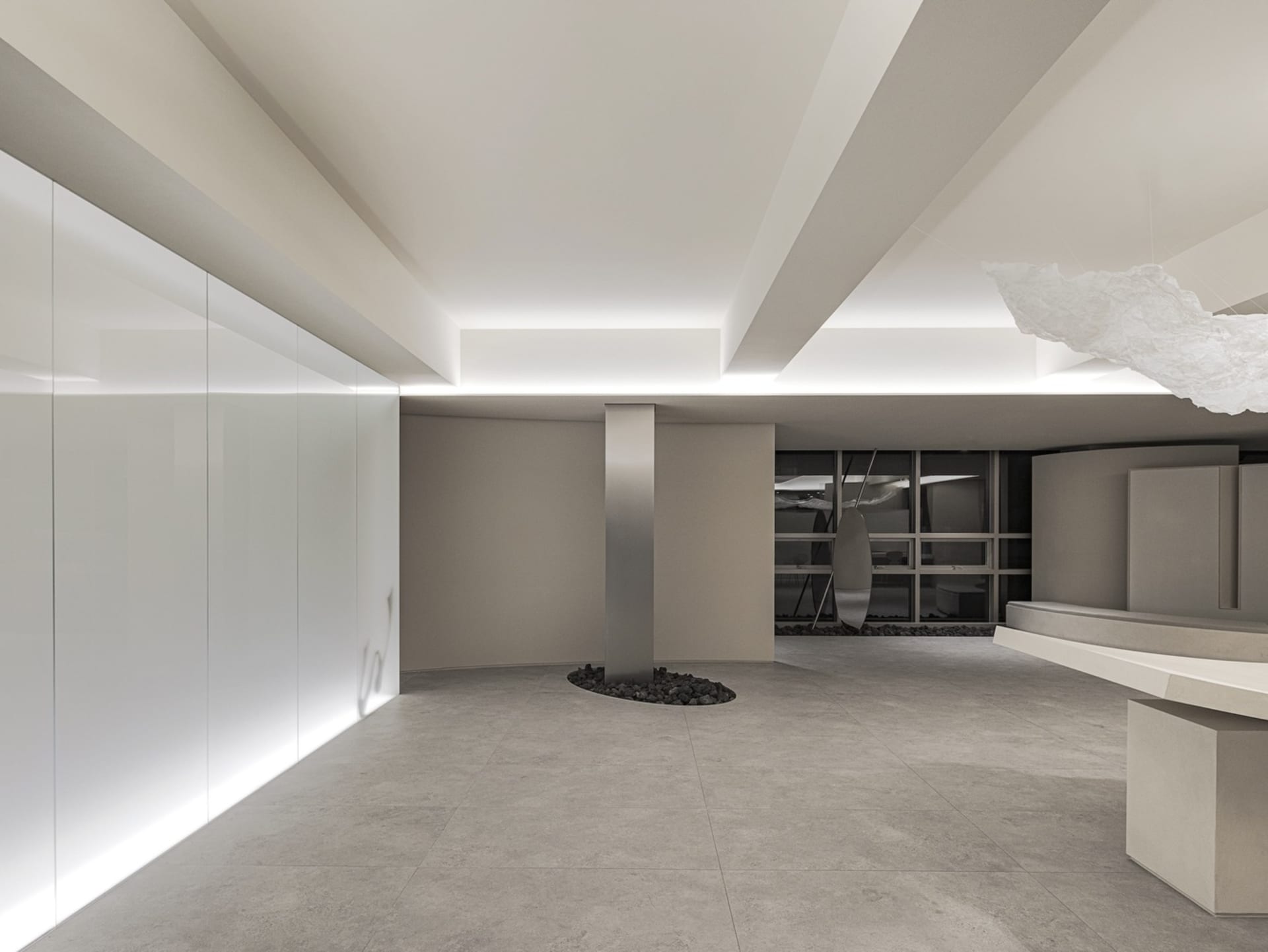 A minimalist office interior featuring a concrete floor and walls.