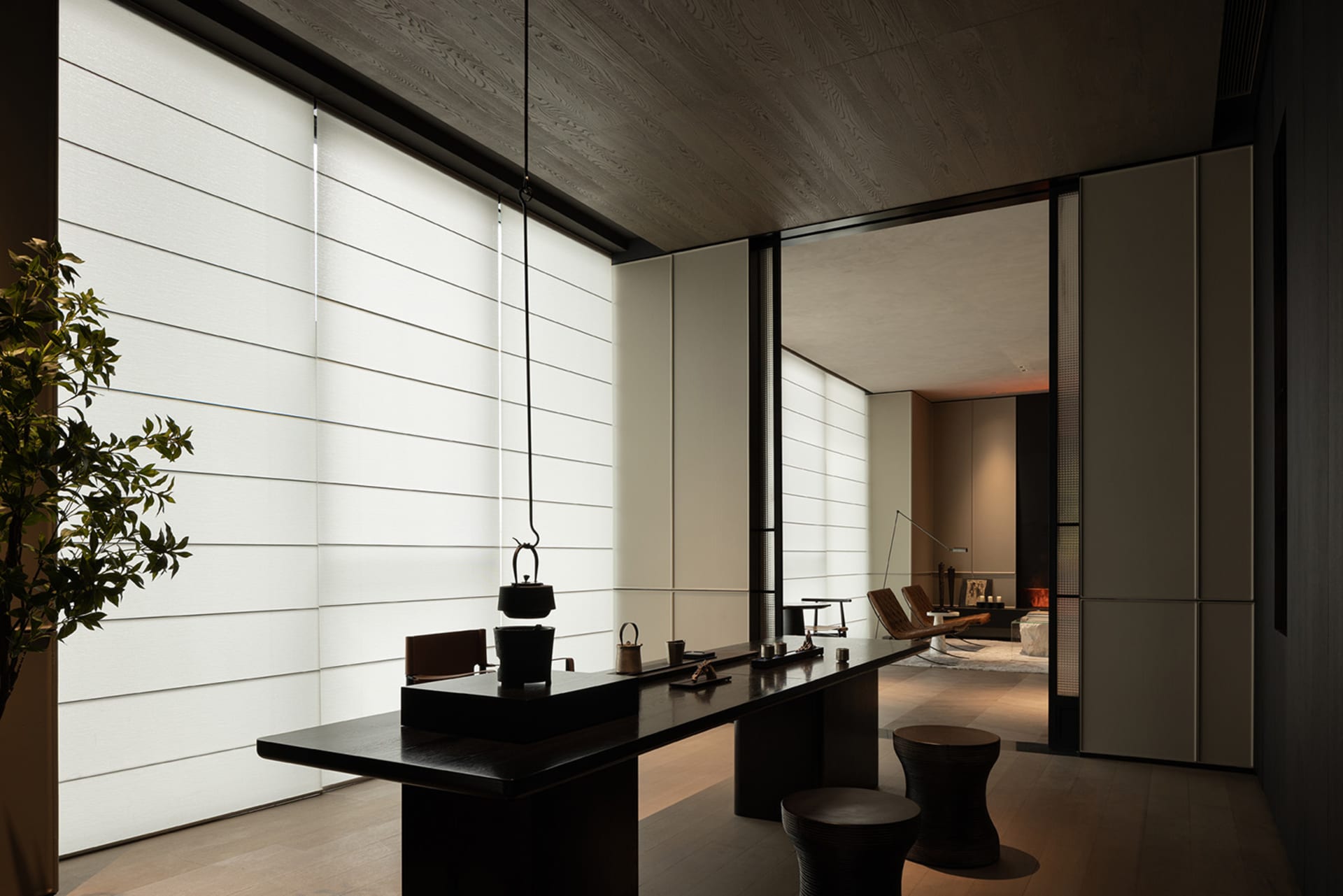 Modern minimalist coffee bar featuring dark wood tables and transparent glass elements.