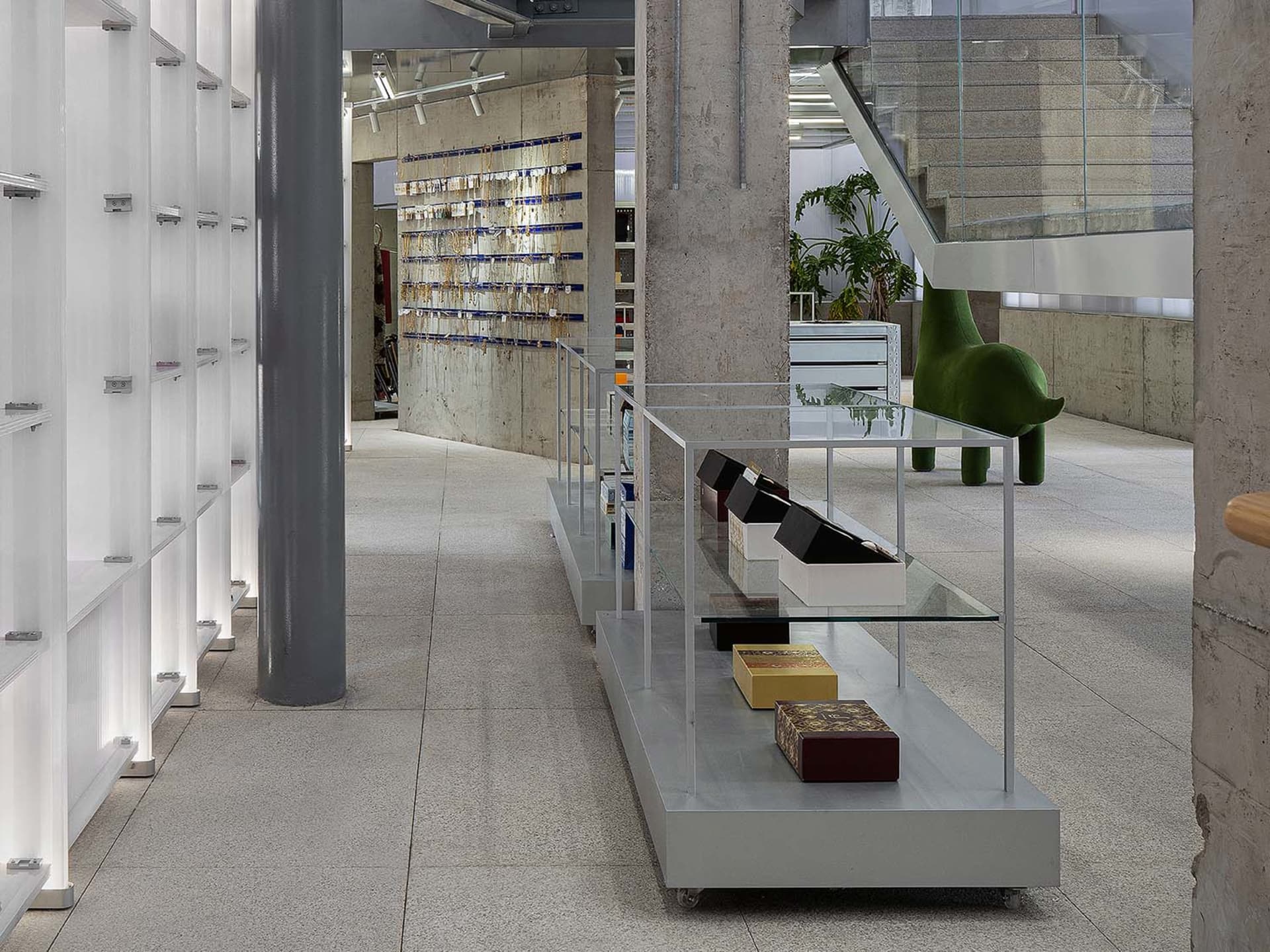 A modern retail shop featuring a transparent display counter with products arranged neatly on shelves.