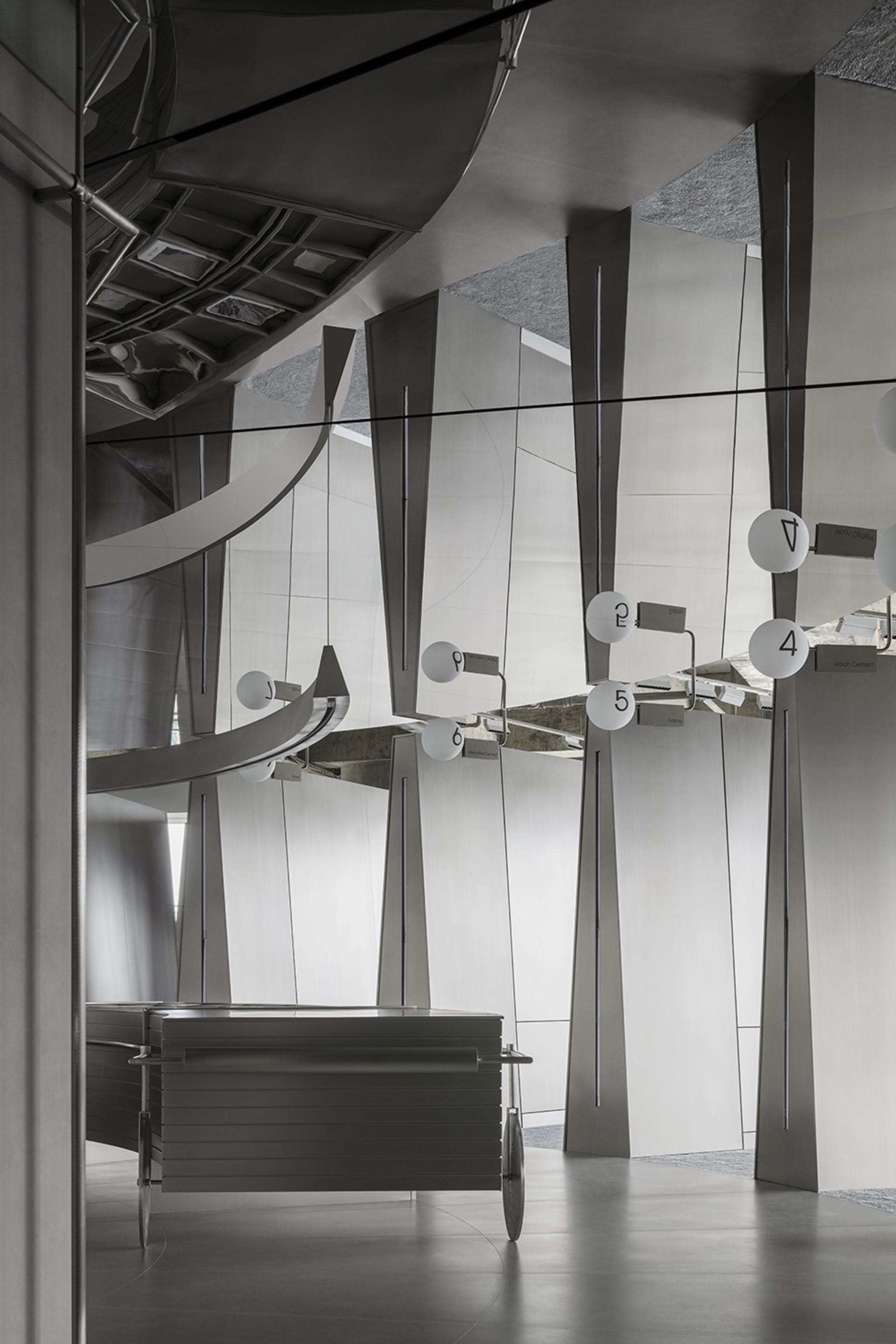 Scalene triangles made of metallic material create a unique and industrial design aesthetic in a corporate space.