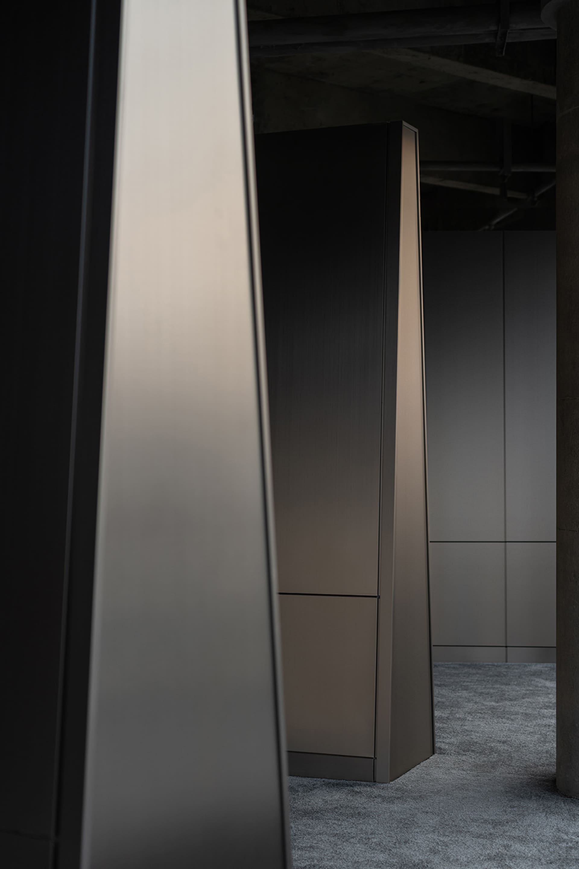 A modern, minimalist closet with metallic finish, featuring sleek lines and a monochromatic color palette, designed for effic