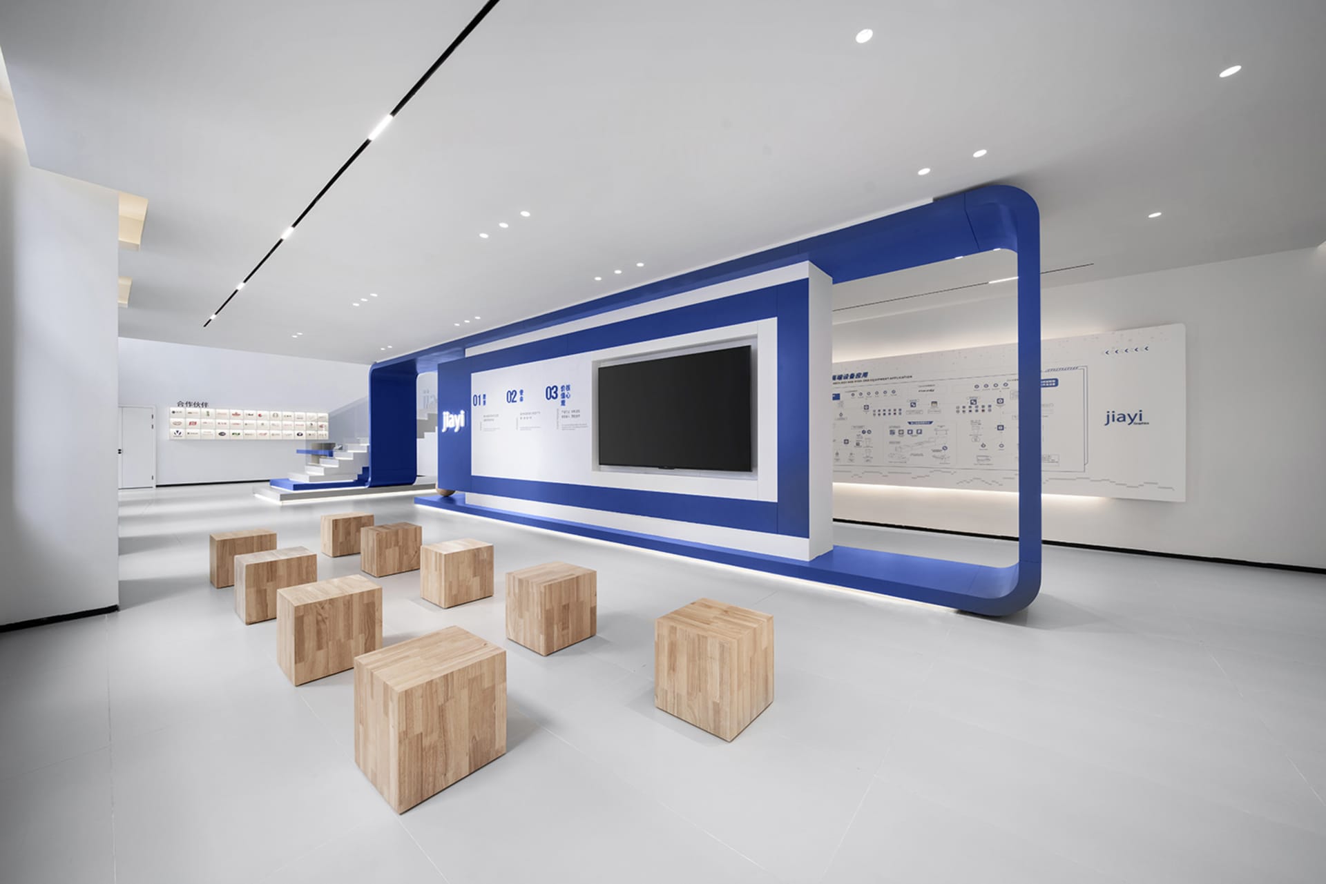 Modern office space featuring wooden furniture and geometric design elements.