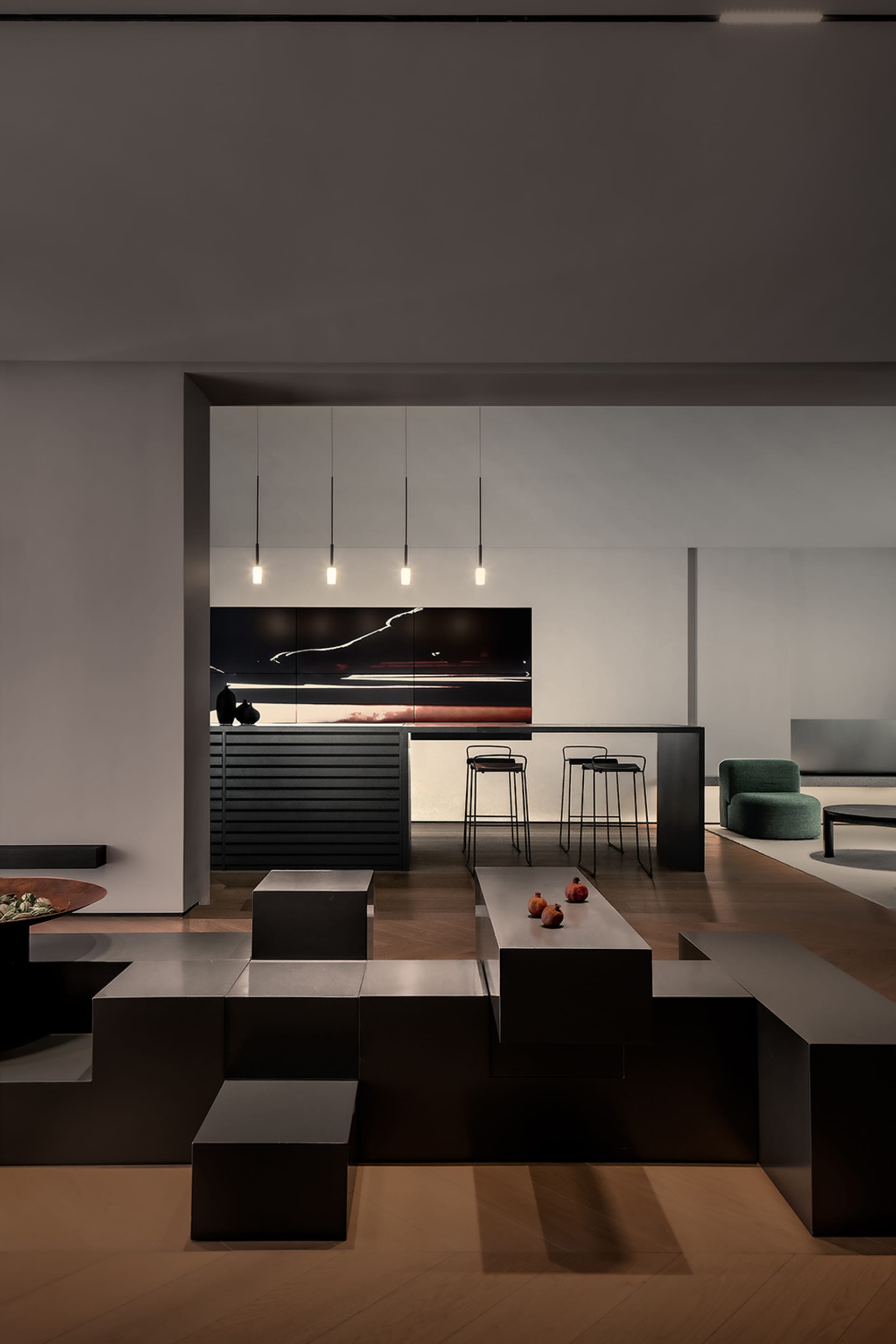 A minimalist living room featuring black metallic furniture and a large abstract painting.