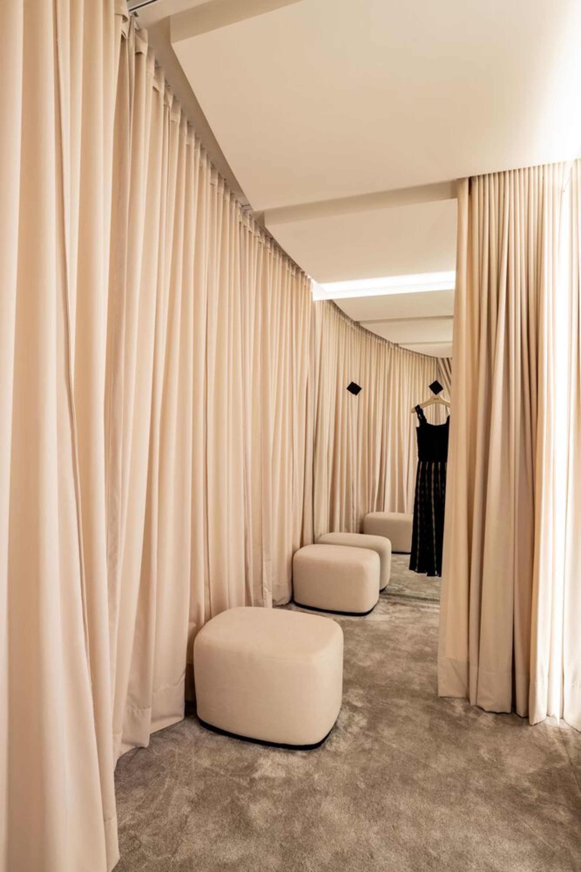 Retail clothing shop with stylish fabric curtains