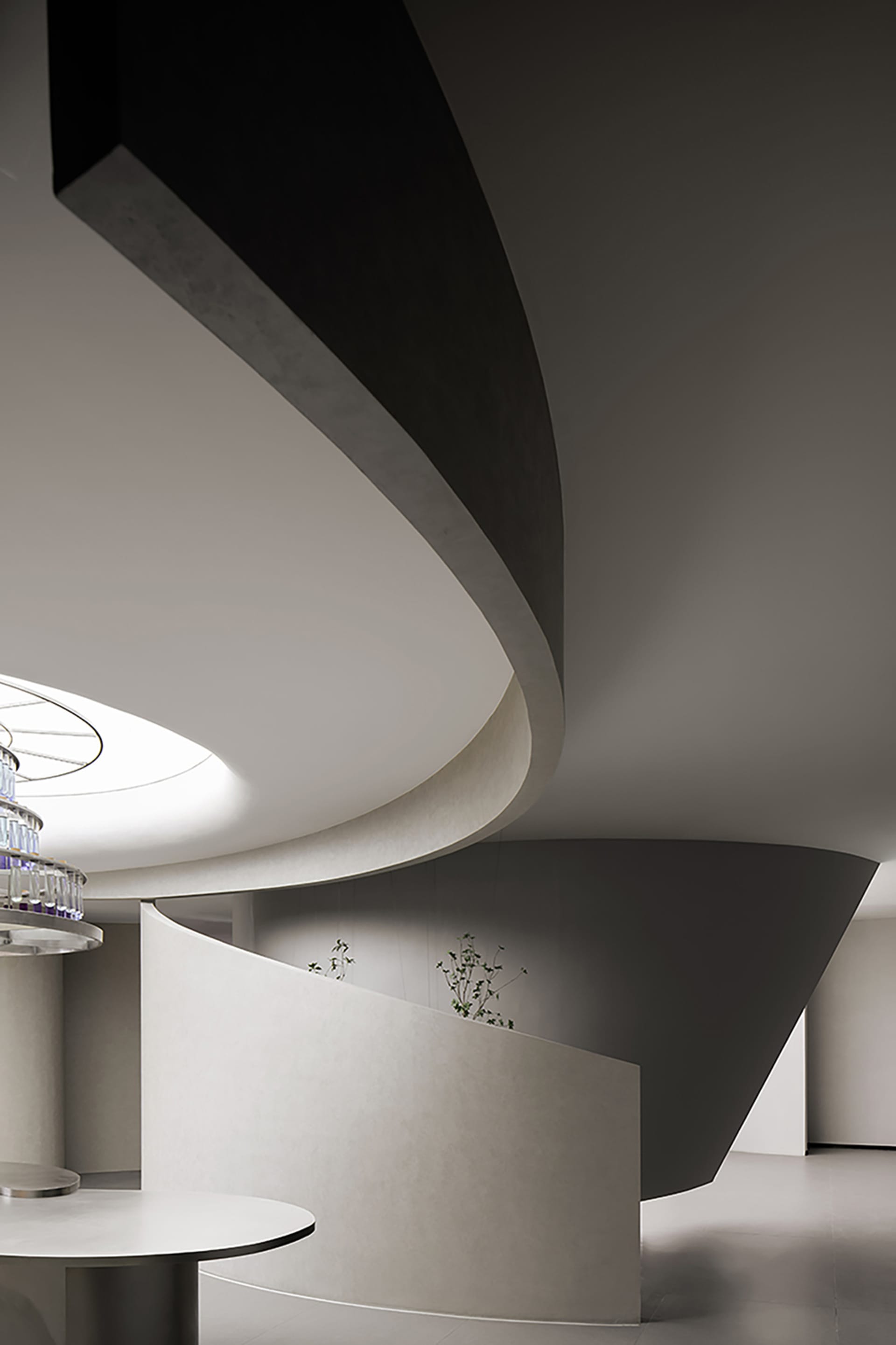 Modern interior with concrete walls and curved architectural elements.