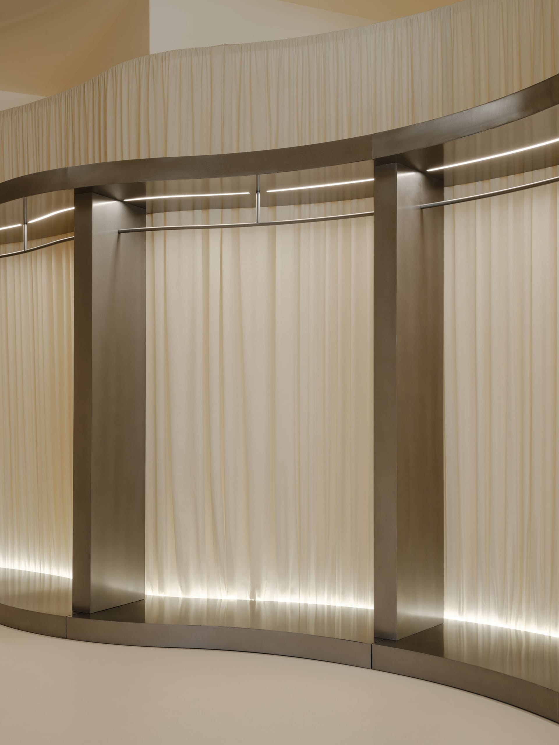 A minimalist clothing rack with a curtain.