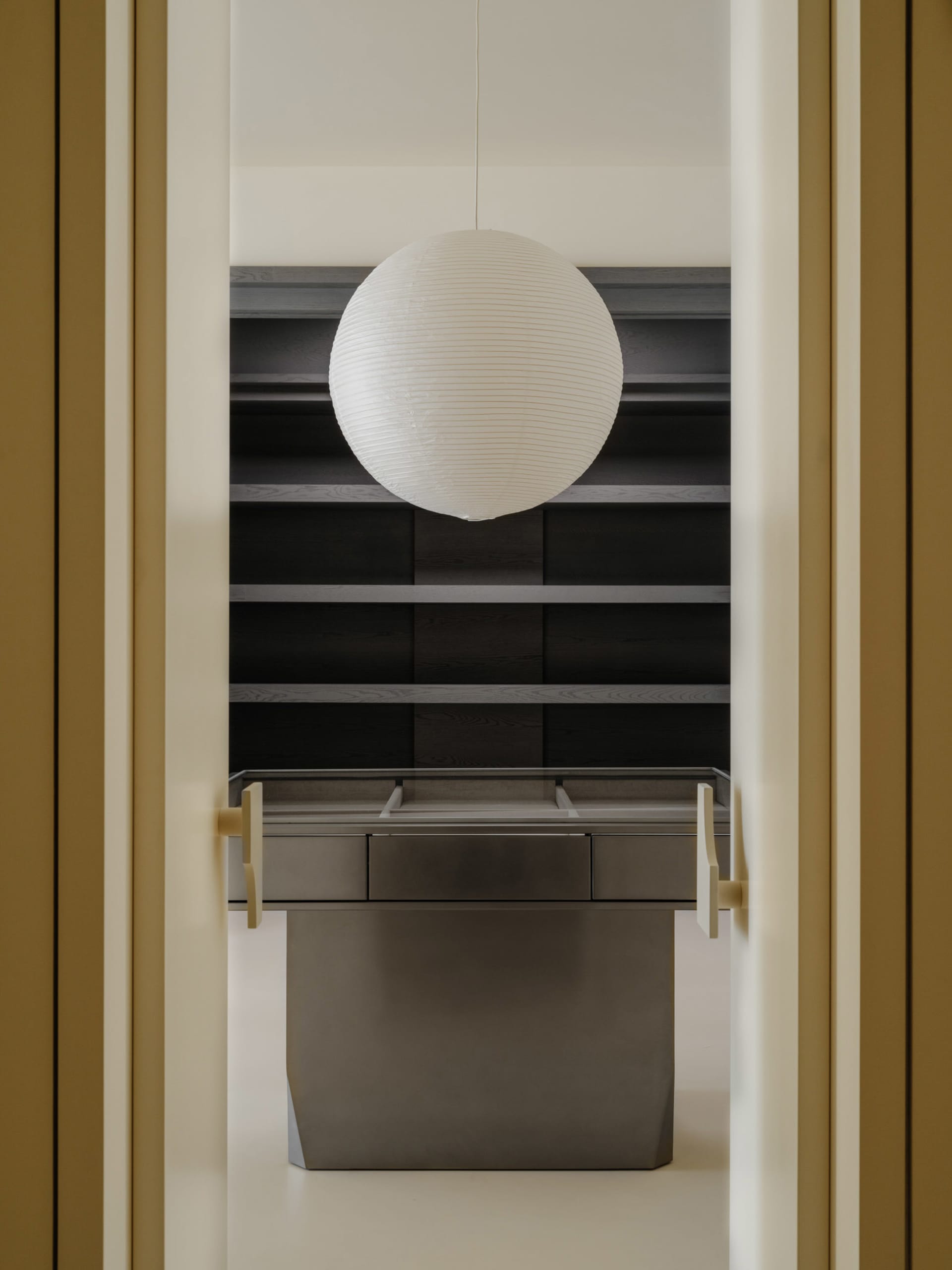 A minimalist wardrobe with metallic drawers and shelves.