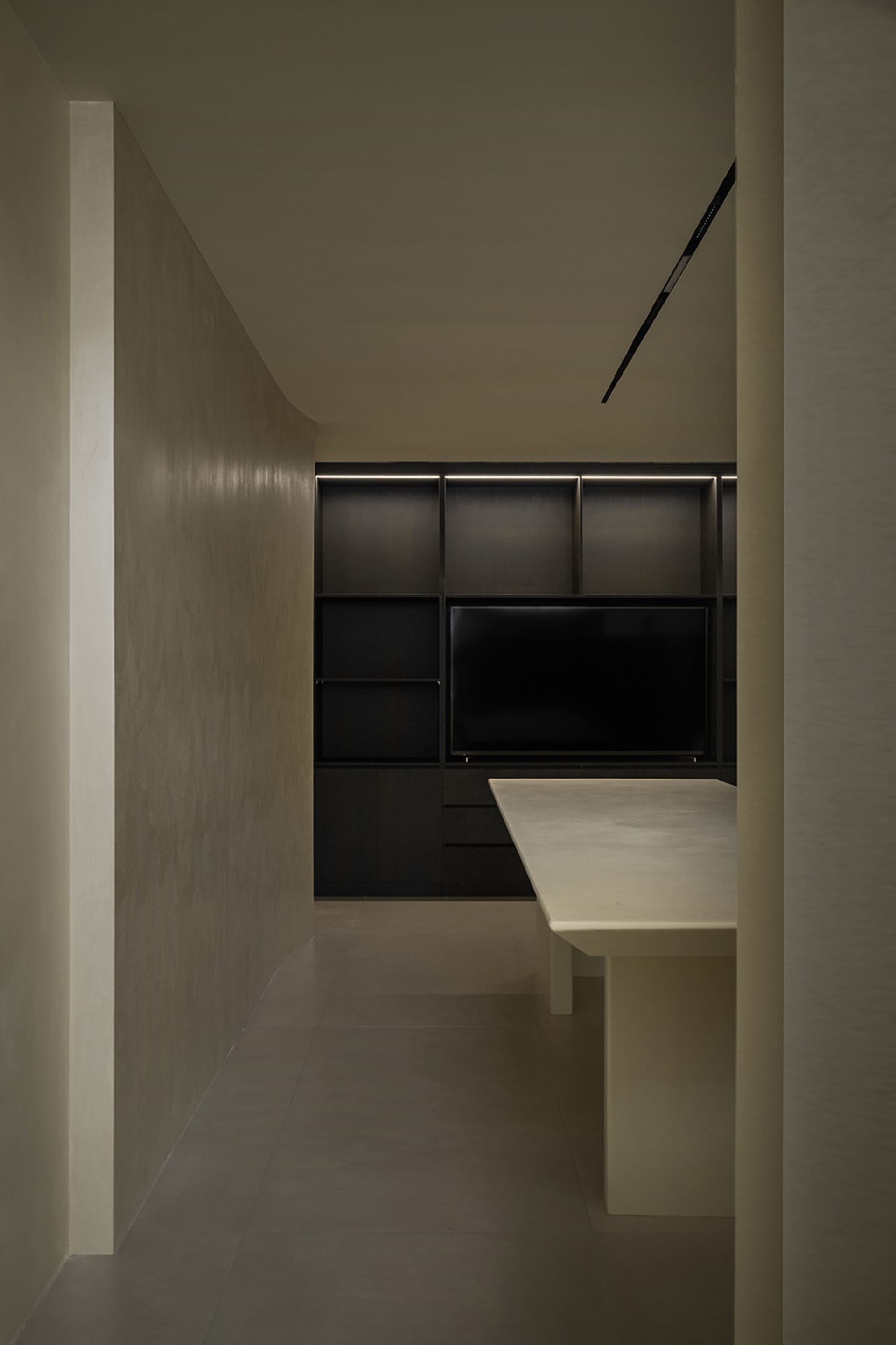 A modern kitchen with a concrete countertop and minimalist design.