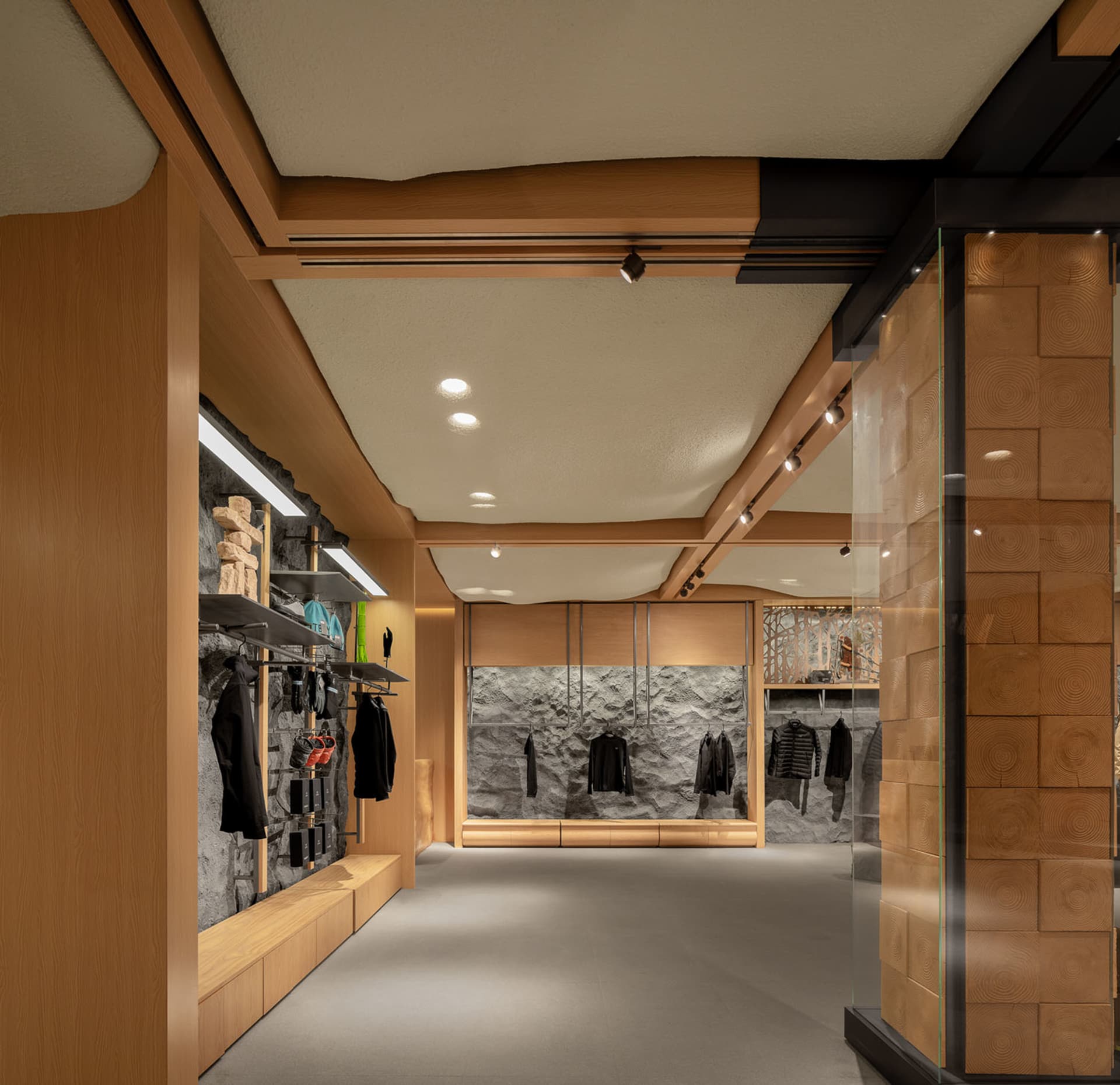 A modern retail store with wooden walls, stone accents, and minimalist design
