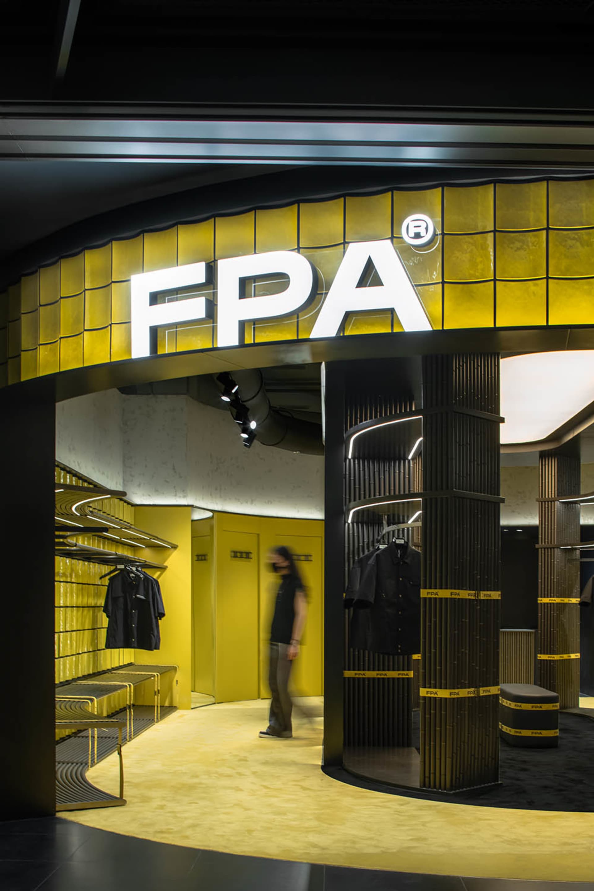 The exterior of a FPA storefront featuring glass tiles and steel columns.