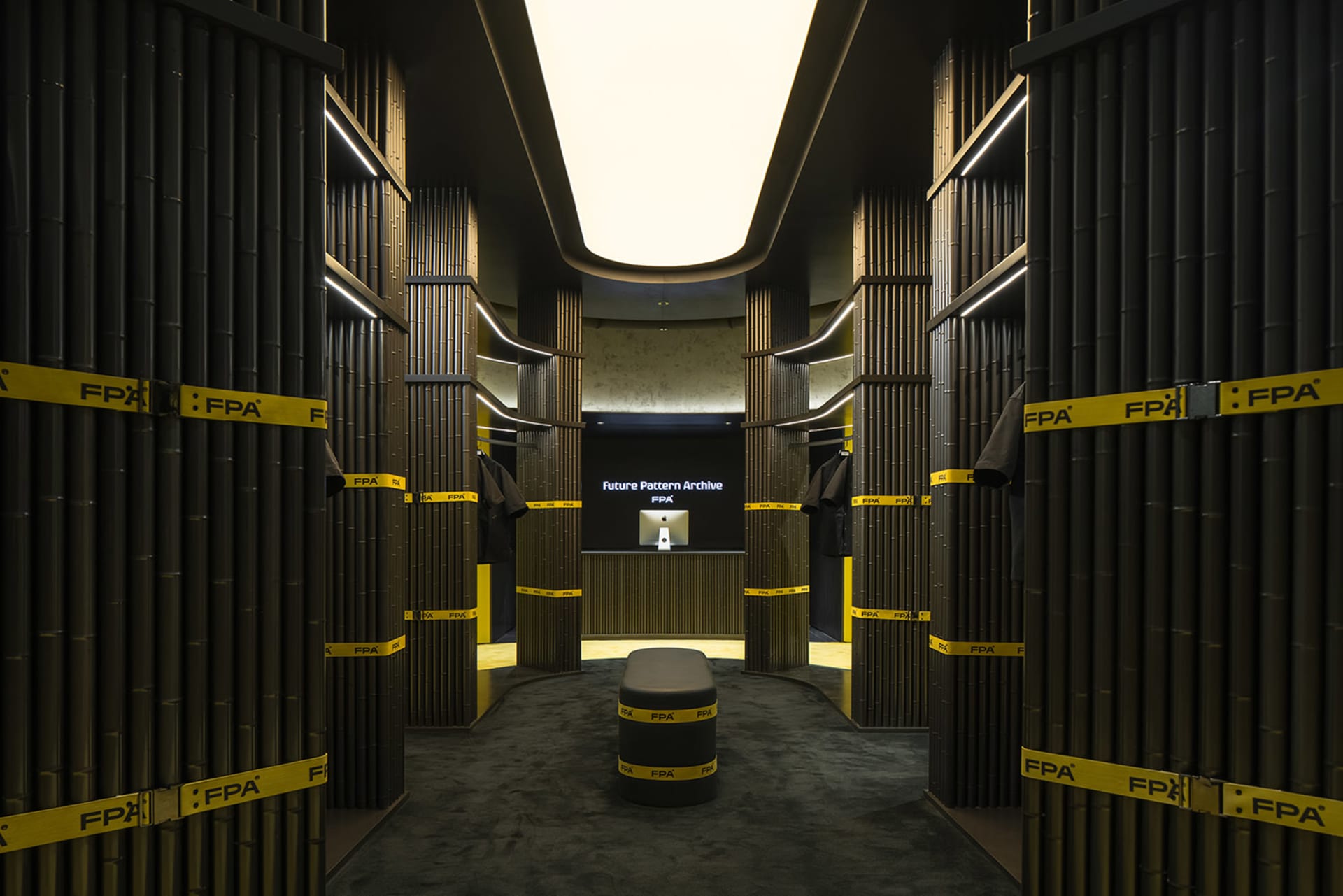 A minimalist clothing retail store featuring wood walls and yellow tape accents