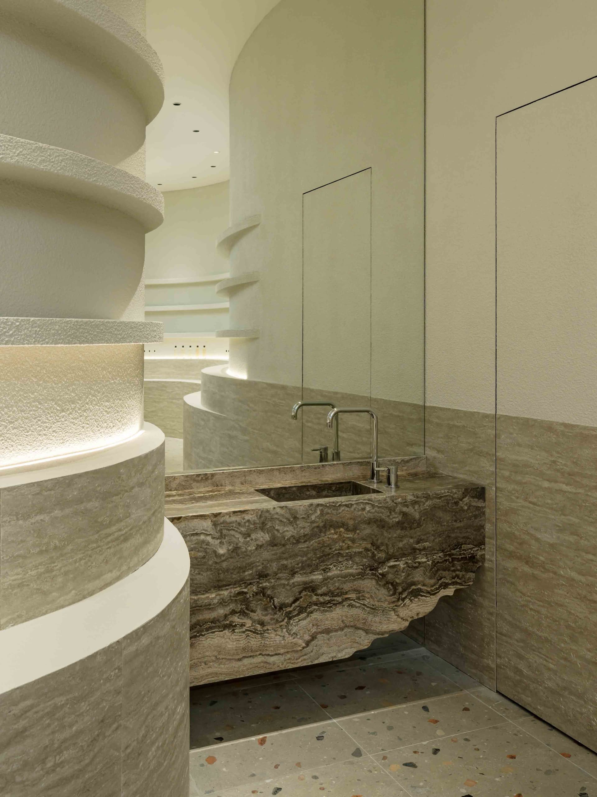 Modern bathroom design featuring sleek, curved terrazzo flooring and minimalist fixtures, creating a contemporary and luxurio