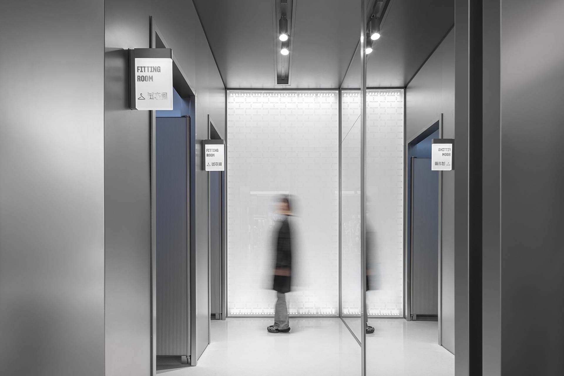 Modern fashion retail store with glass walls and metallic accents