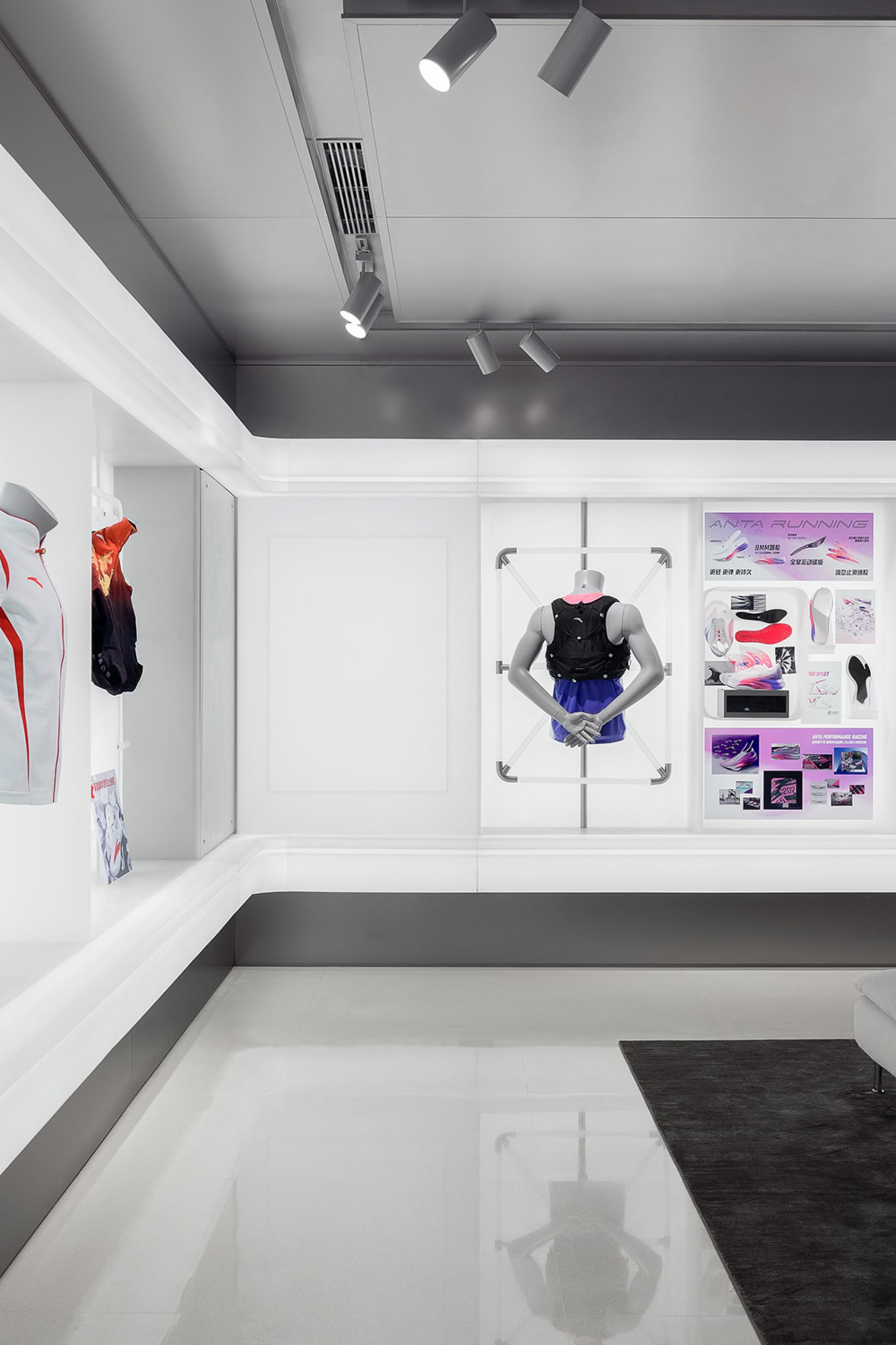 Modern retail space featuring white concrete floors, glass display cases, and minimalist design elements.