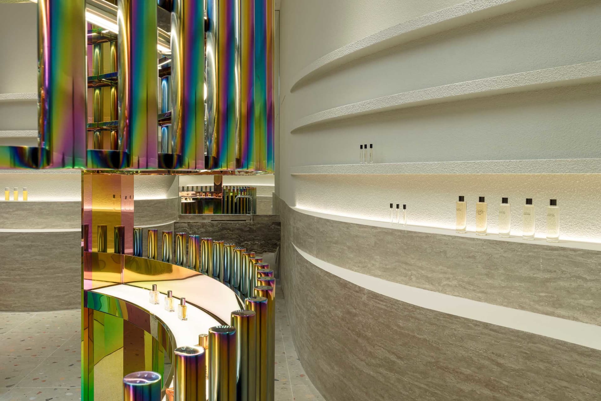 Modern retail storefront with metallic columns and concrete wall