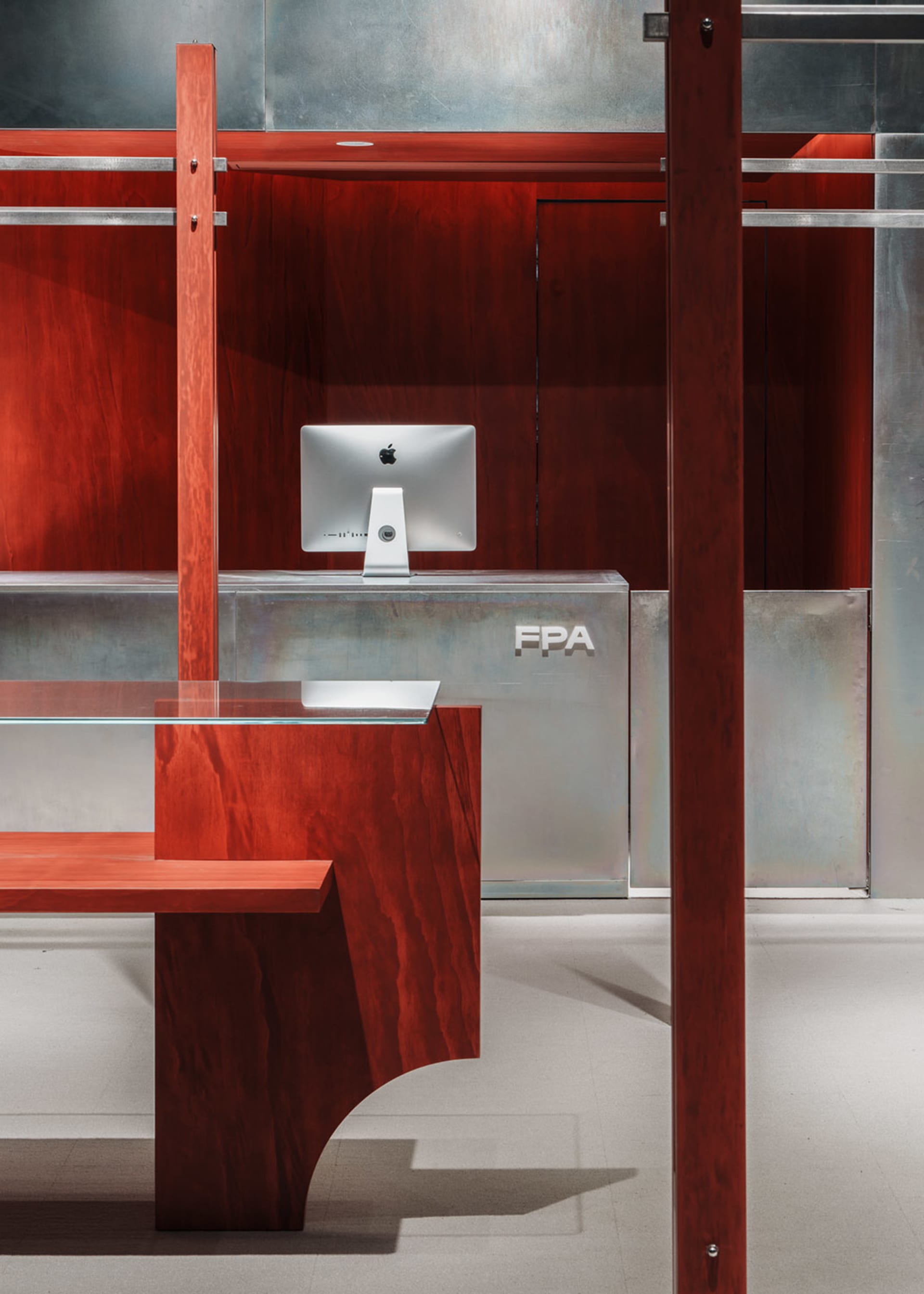 An industrial retail shop interior with metal shelves and a wooden desk.