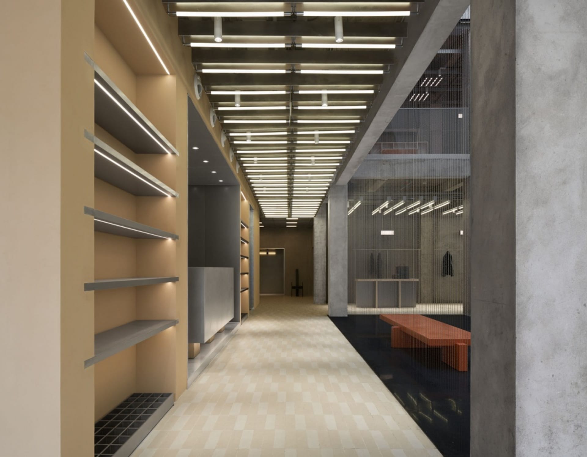 Industrial storefront with exposed concrete walls and a minimalist design.