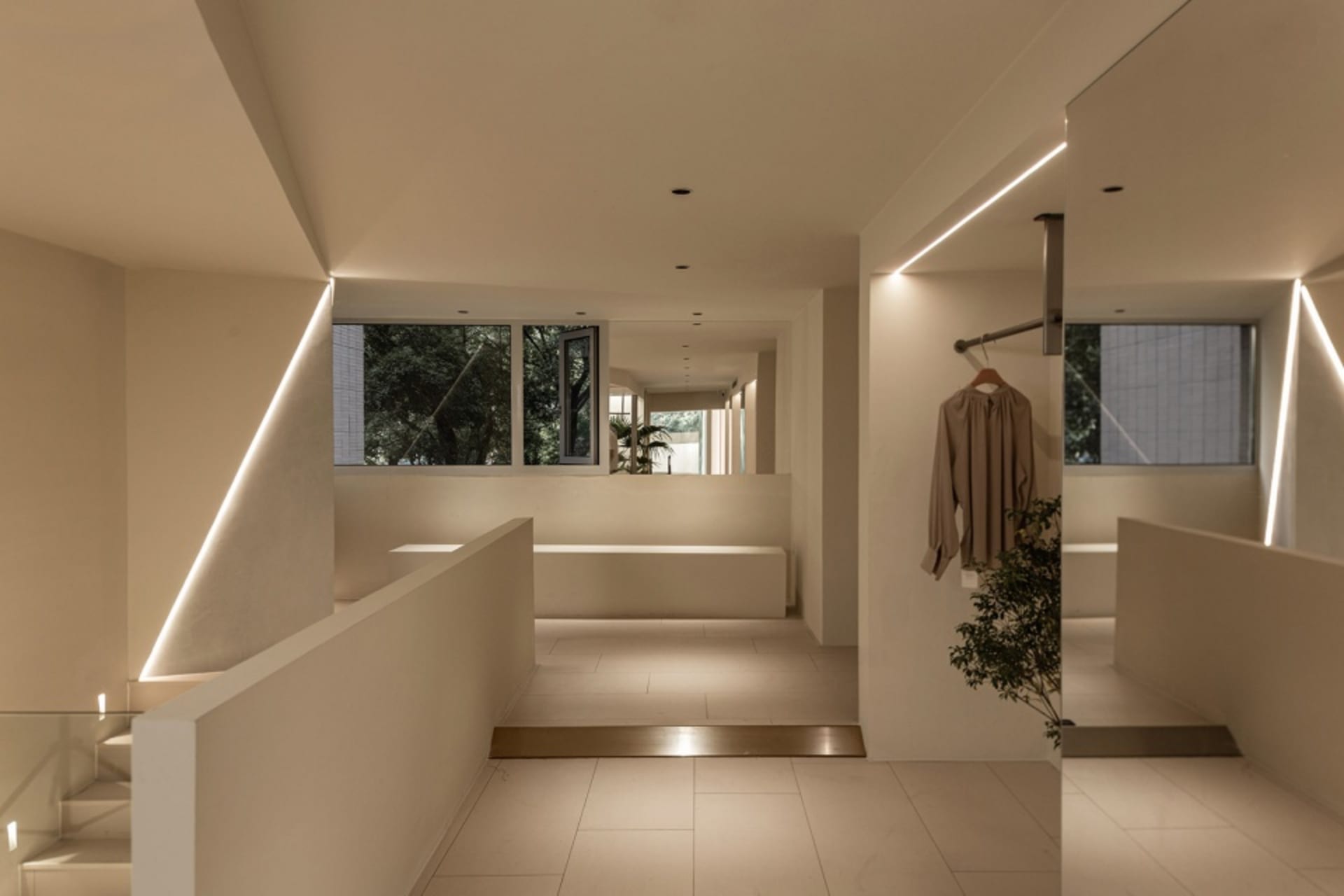 An industrial-style, modern interior space with concrete finishes and large windows.
