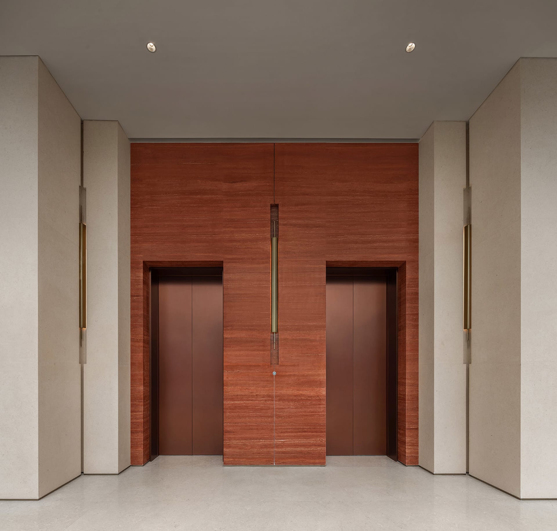 The image depicts a modern lobby featuring concrete walls and wooden elevator doors.
