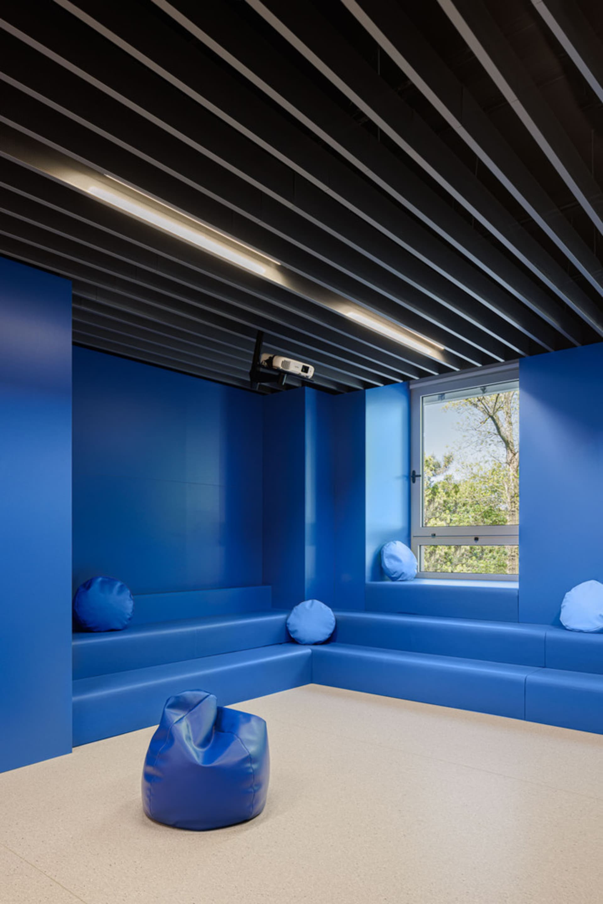 Modern education space with blue walls and seating area.